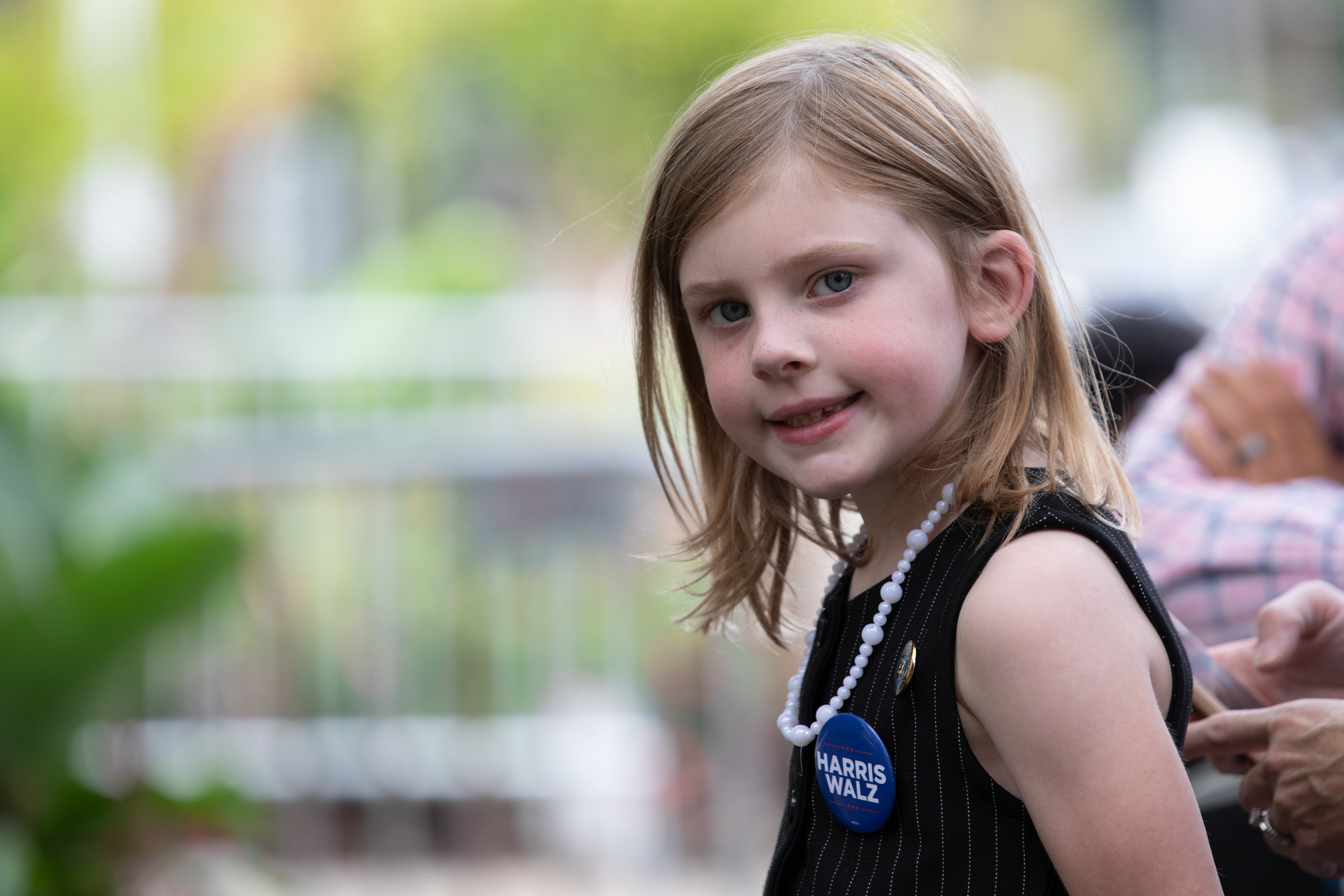 A young girl smiles while at Kamala Harris's campaign event in Pittsburgh, Pennsylvania, September, 25, 2024.