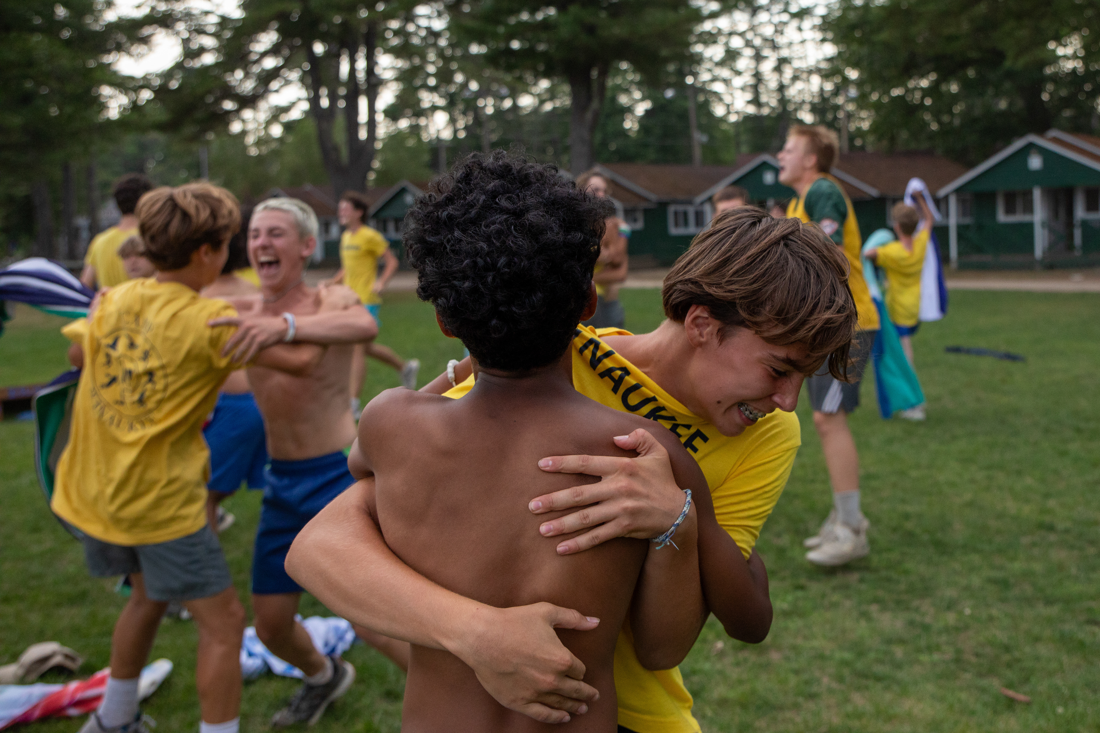 Emery Elkinson and Aidan Smith embrace after winning a relay race during Color War at Camp Winaukee in Moultonborough, New Hampshire, Aug. 12, 2025.