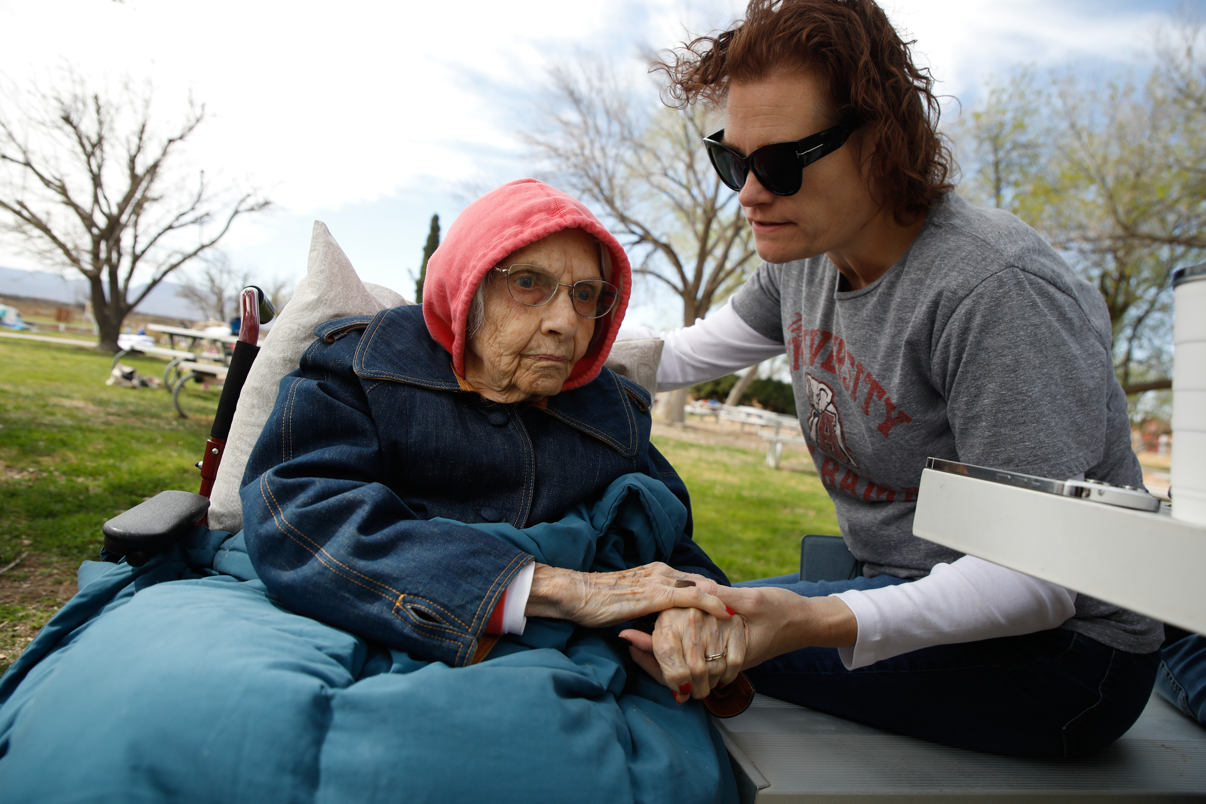 Tawney Williams holds hands with her 102 year old grandmother, Clara Bass, in Balmorhea, Texas, March, 12, 2024.