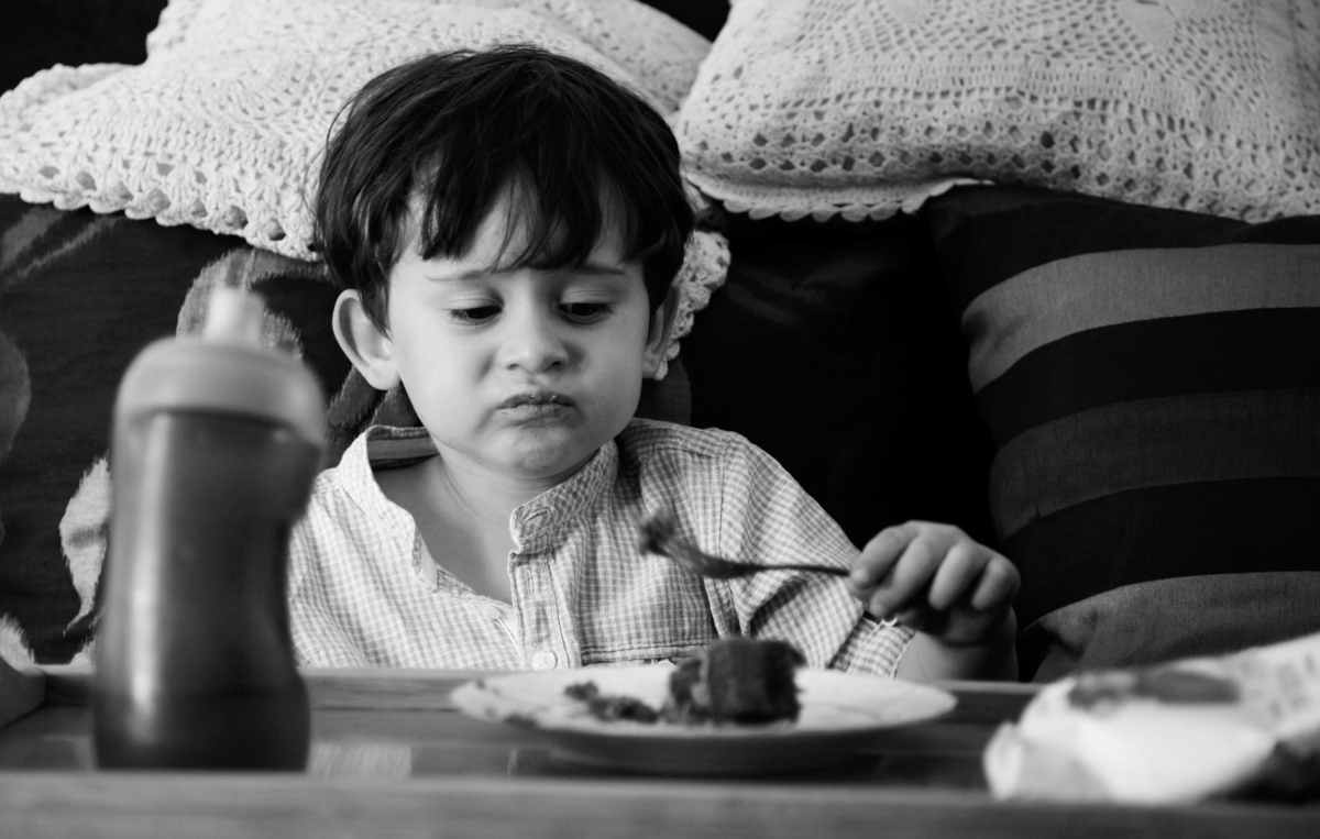 Portrait of a boy disgusted with food. Photography by © Ewa Brykowska. All Rights Reserved.