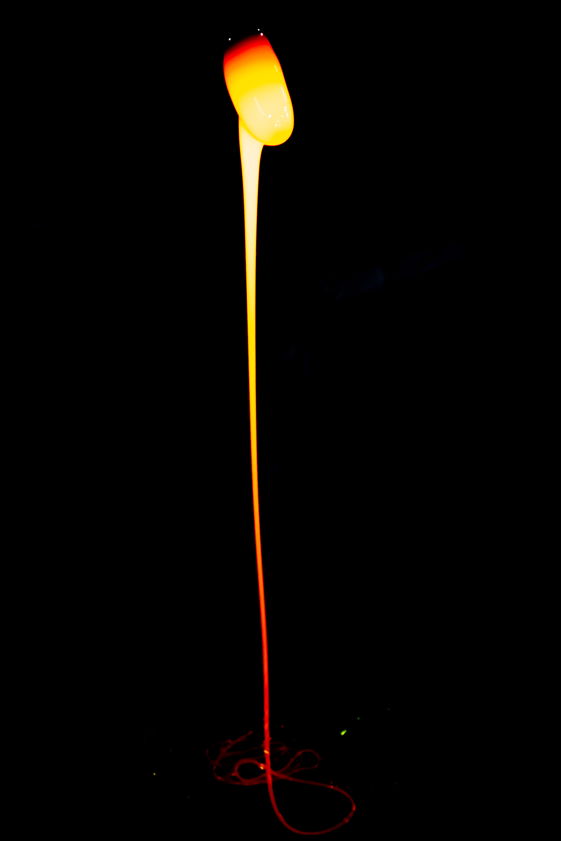 Molten glass drips from a blowpipe during the crafting of Ryukyu Glassware at Ryukyu Glass Village. The glass, in its molten state, can reach temperatures ranging from 1700 F (930 C) to 2200 F (1200 C).