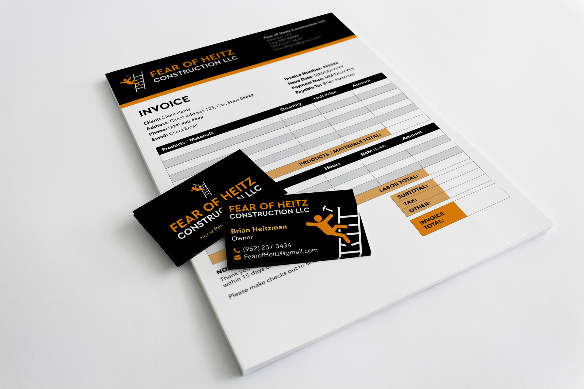 Business cards and an invoice for Fear of Heitz Construction