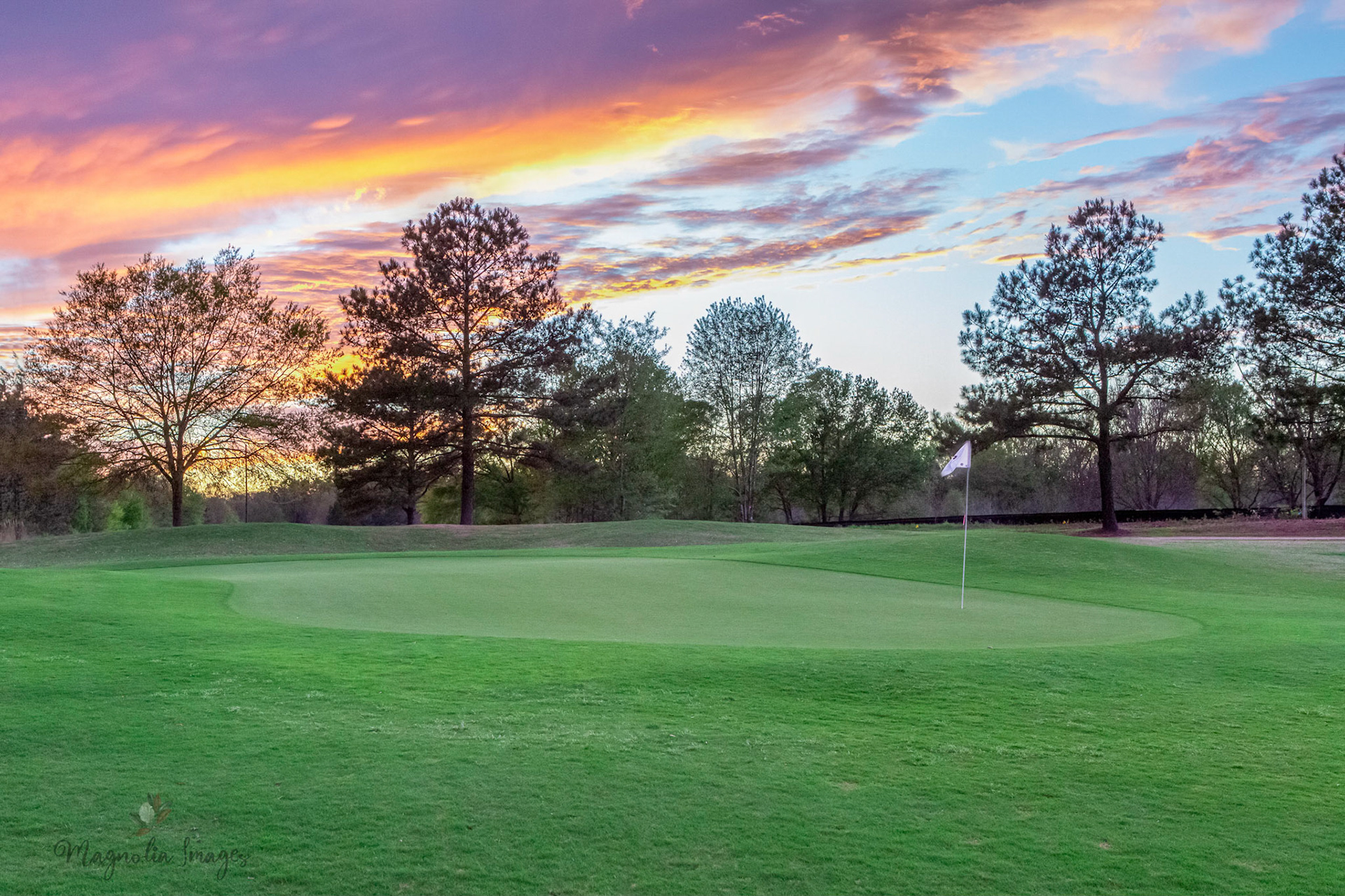 An orange and pink sunset for the green on No. 13