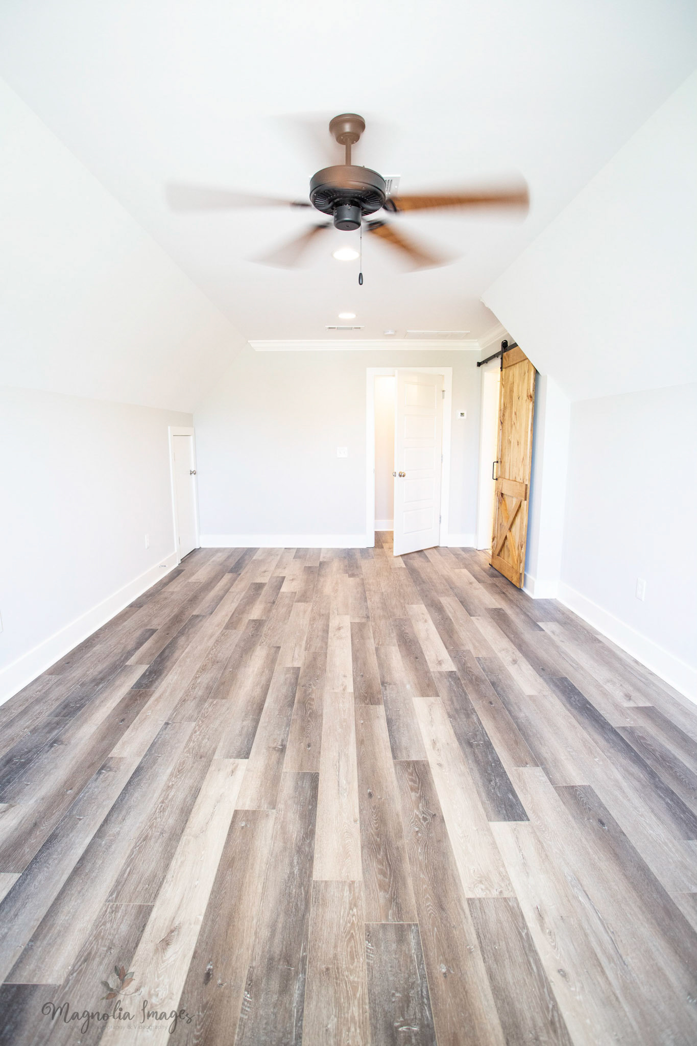 Bonus room above the garage with full bathroom accented by barn door