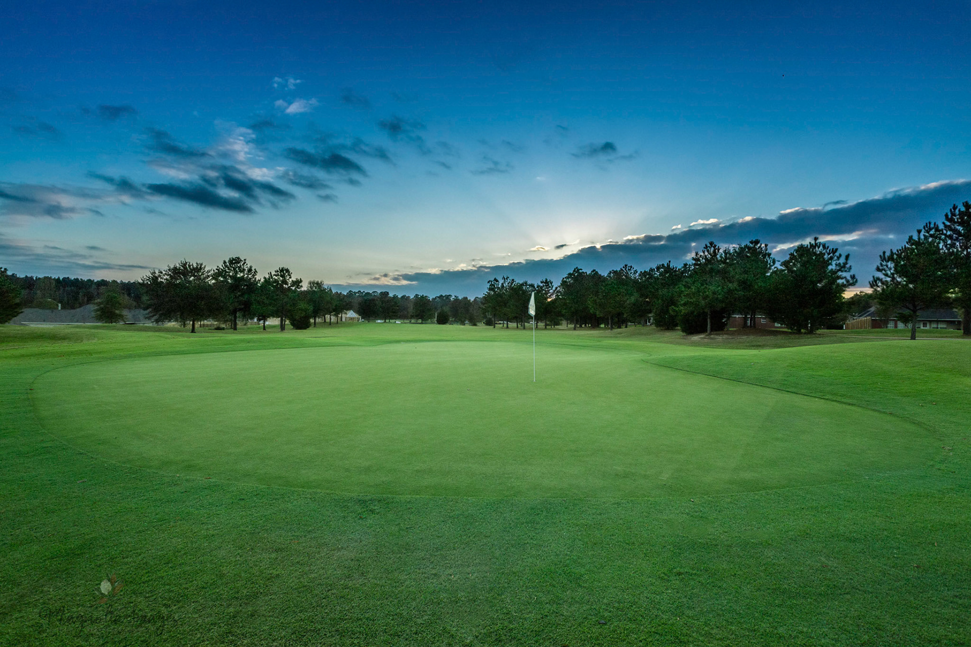 Last light peeks out from behind the clouds from the back of No. 17 fairway