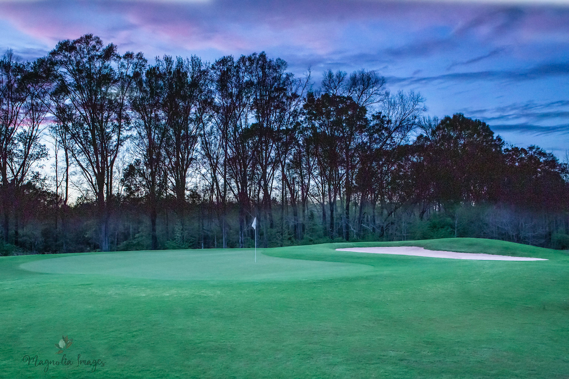 Purple skies signal dusk on the 14th green