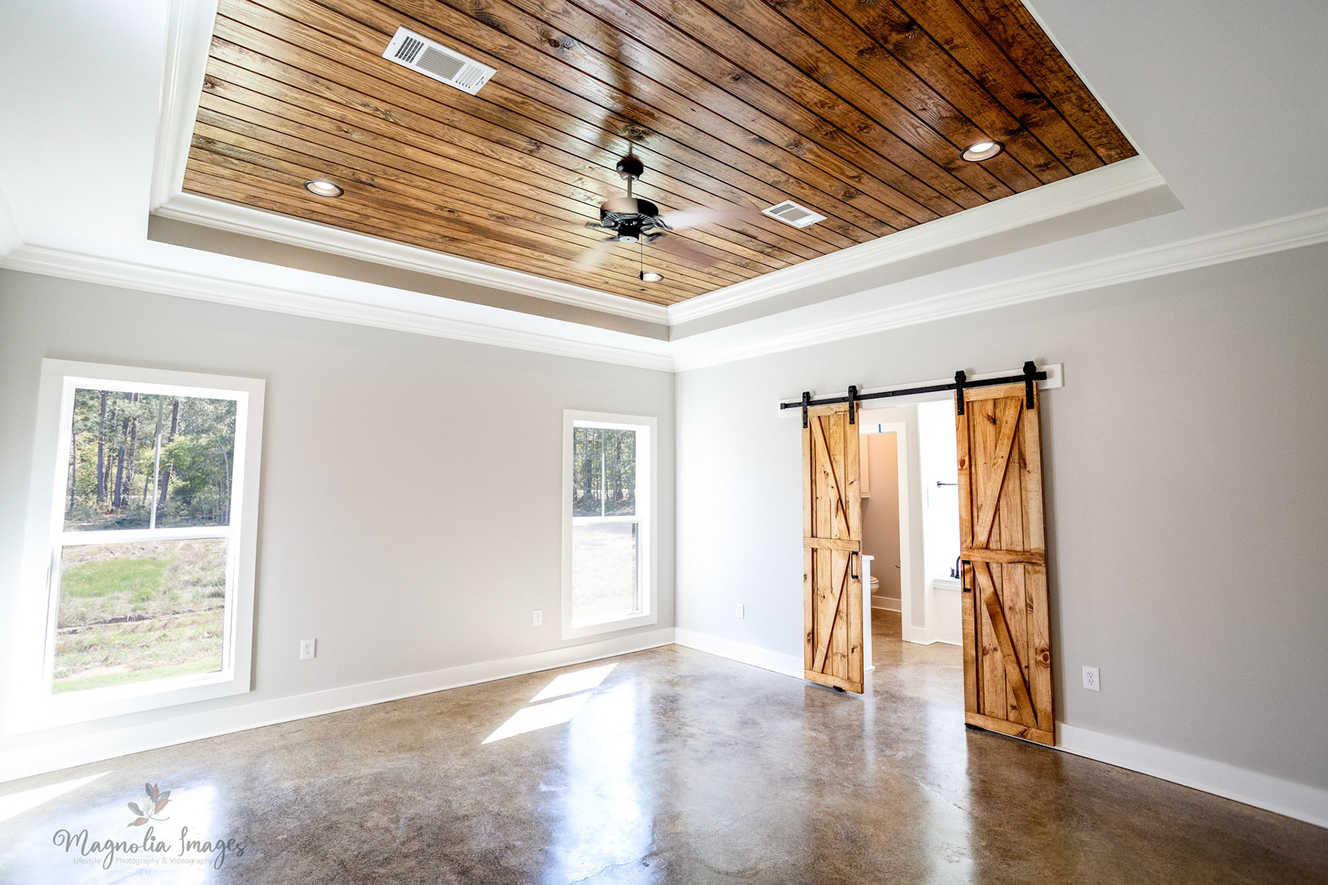 Master bedroom, trey ceiling, barn doors leading into master bathroom