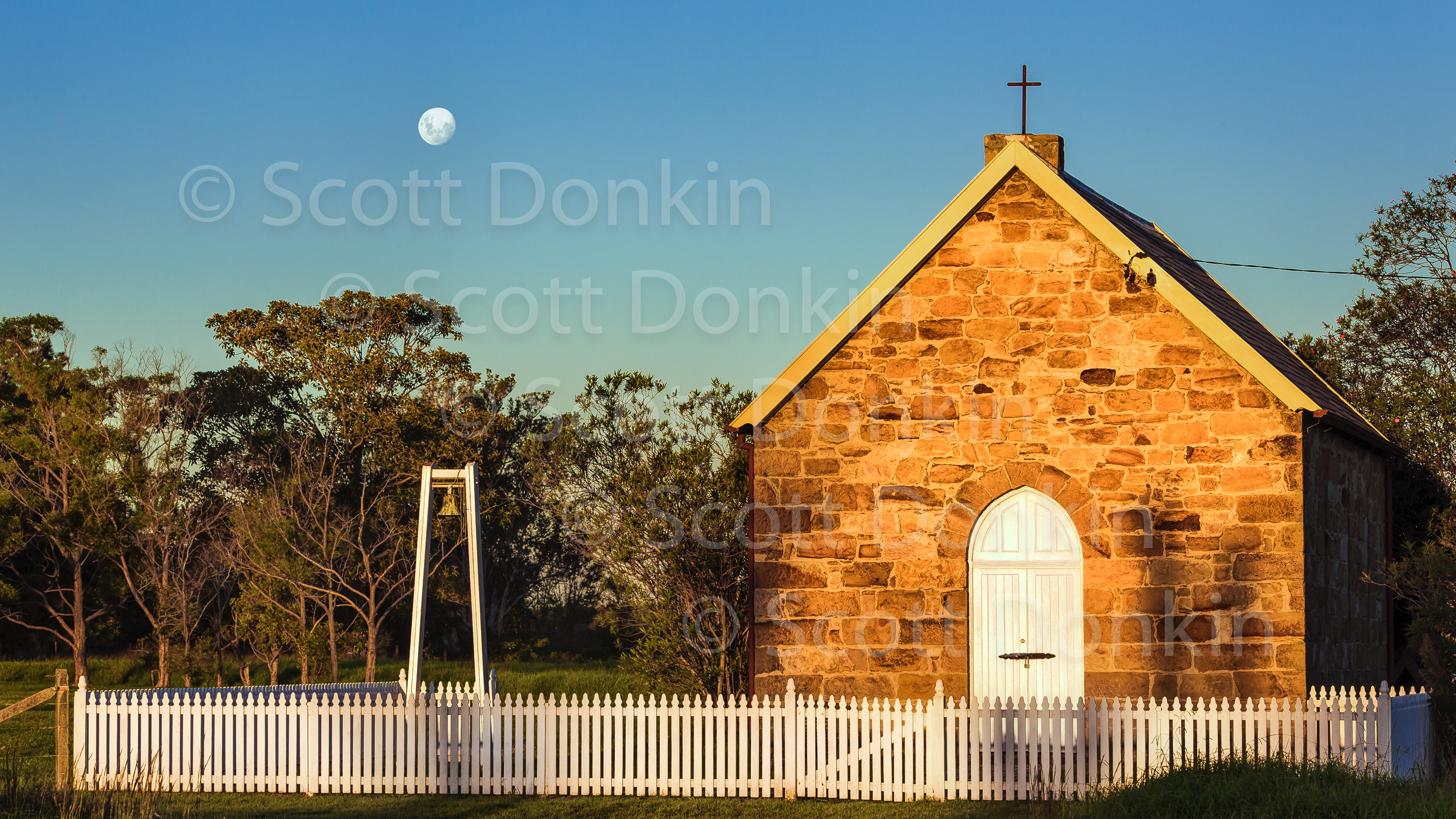 TOMAGO, NSW, AUSTRALIA - 9 April 2017: Moonrise over a small rural chapel in the New South Wales Hunter region. Waxing moon wth 96% disc illumination at 5:16pm. Single exposure.