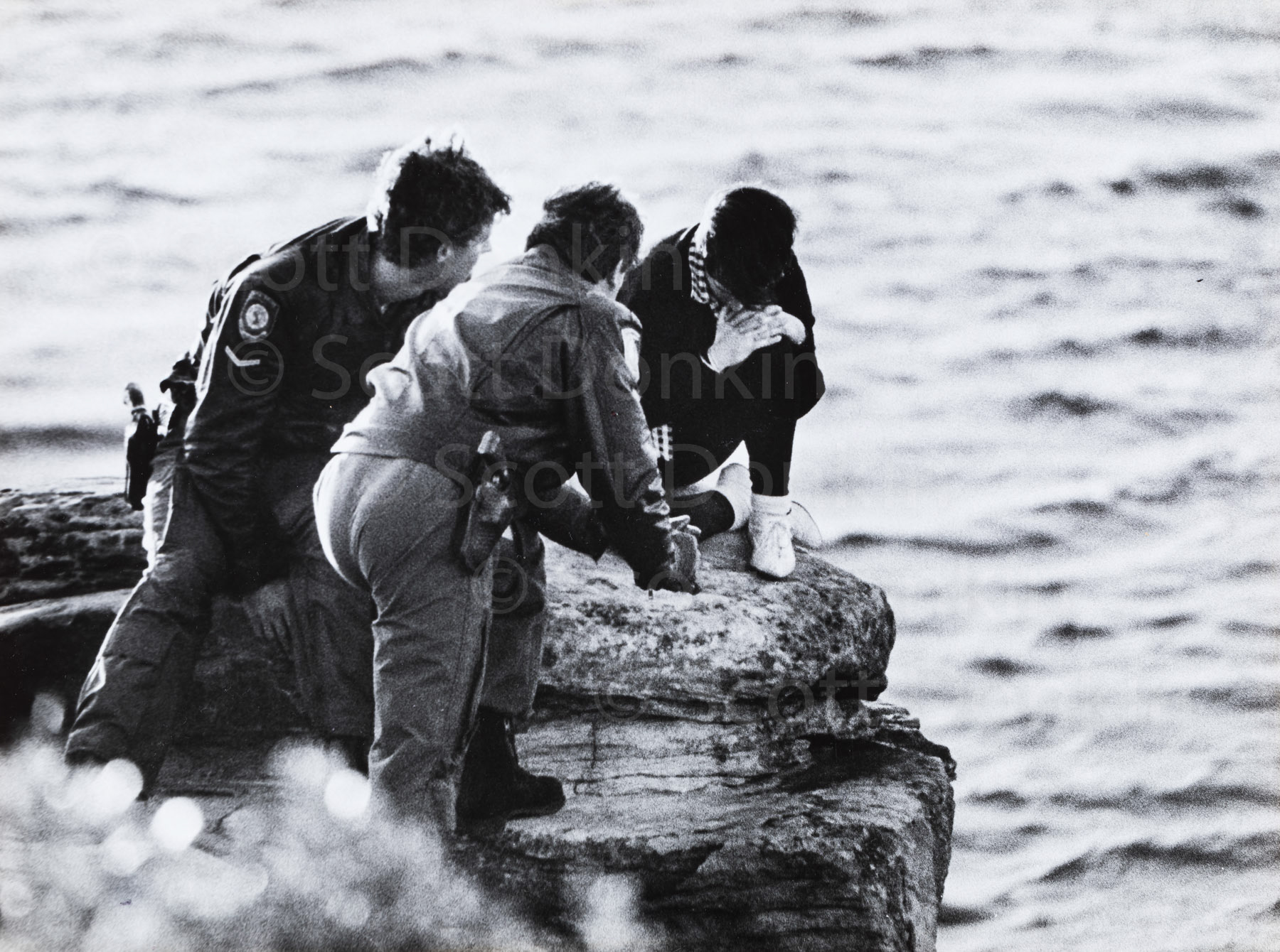 Dramatic rescue of a young woman contemplating suicide on a rock outcrop.  Shelley Beach cliffs, Manly 1984.  Published nationally. (Copy from original B&W print).