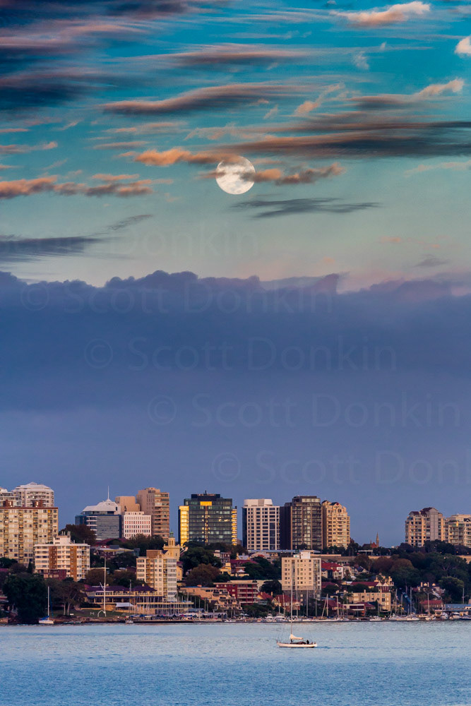 KIRRIBILLI, NSW, AUSTRALIA - 3 March 2018: A full moon over the North Sydney skyline at sunrise. Waning, 99.1% disc illumination. Single exposure.
