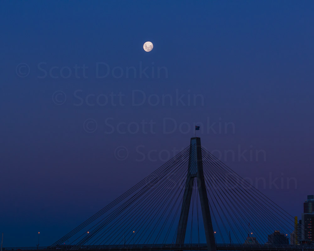 SYDNEY, NSW, AUSTRALIA - 28 February 2018:  Moon rise over the ANZAC Bridge at 7:36pm, an hour after sunset.  Waxing moon with 96% disc illumination.  Single exposure.