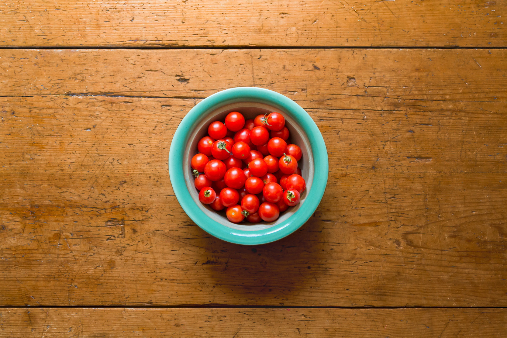 Bowl of cherry tomatoes with space for copy.