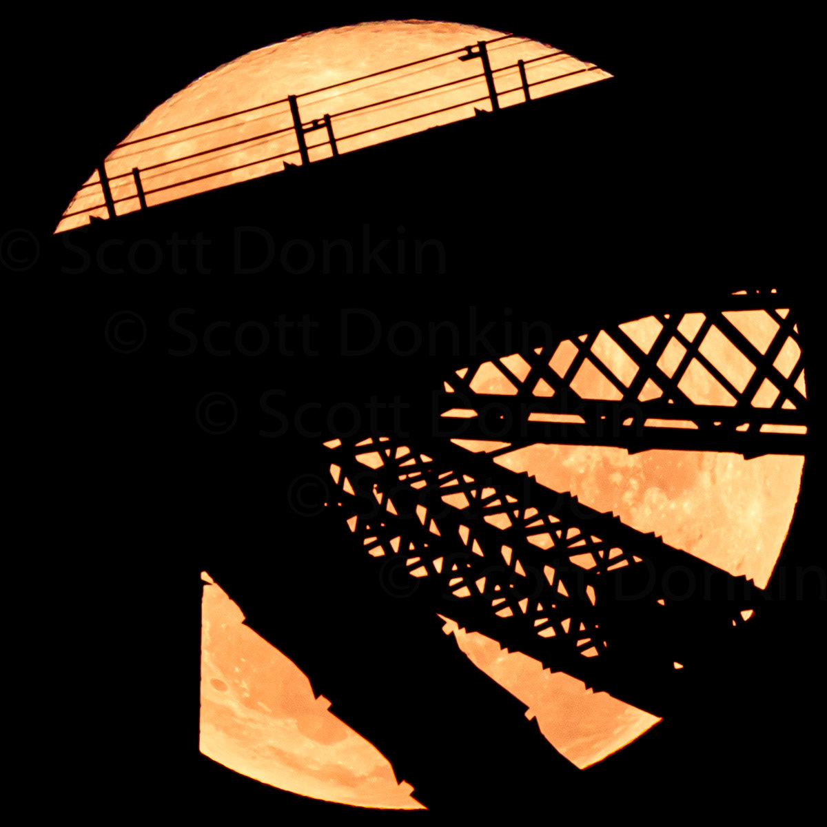 Sydney Harbour Bridge in silhouette against a rising super moon. Full super pink moon. 7:22pm Tuesday 27 April 2021.