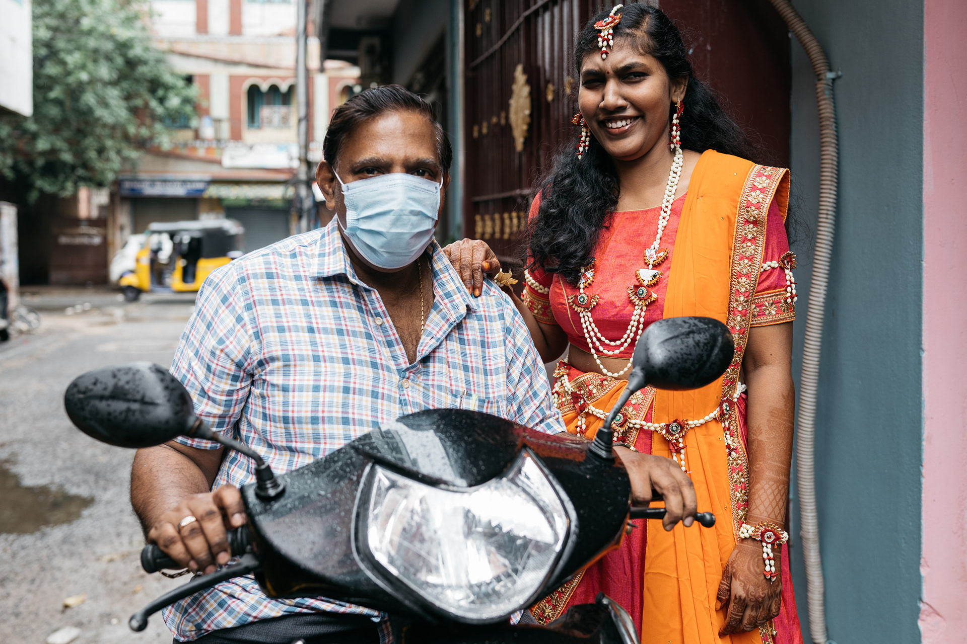Bride with her dad outside her home