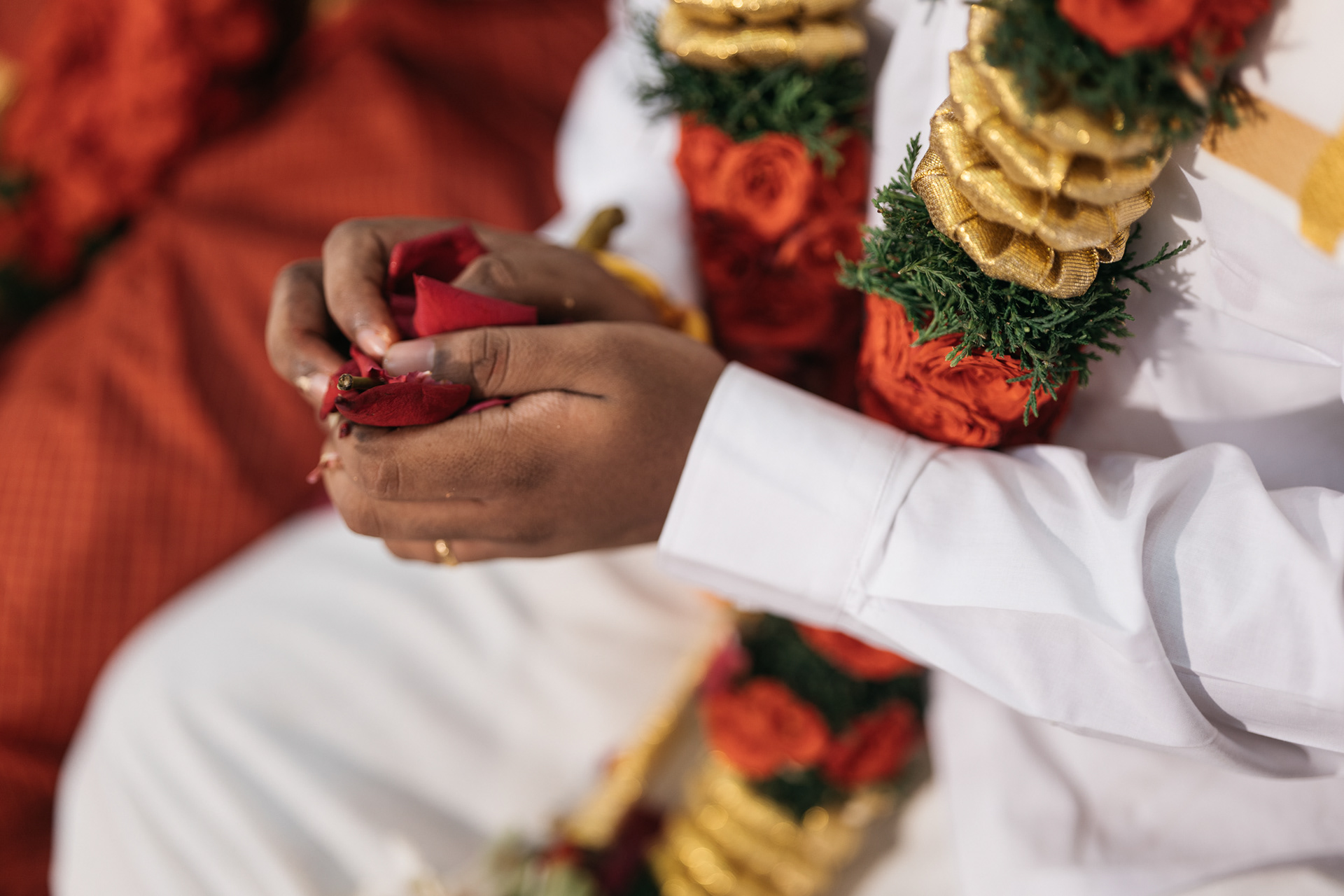 Grooms hand full of petals