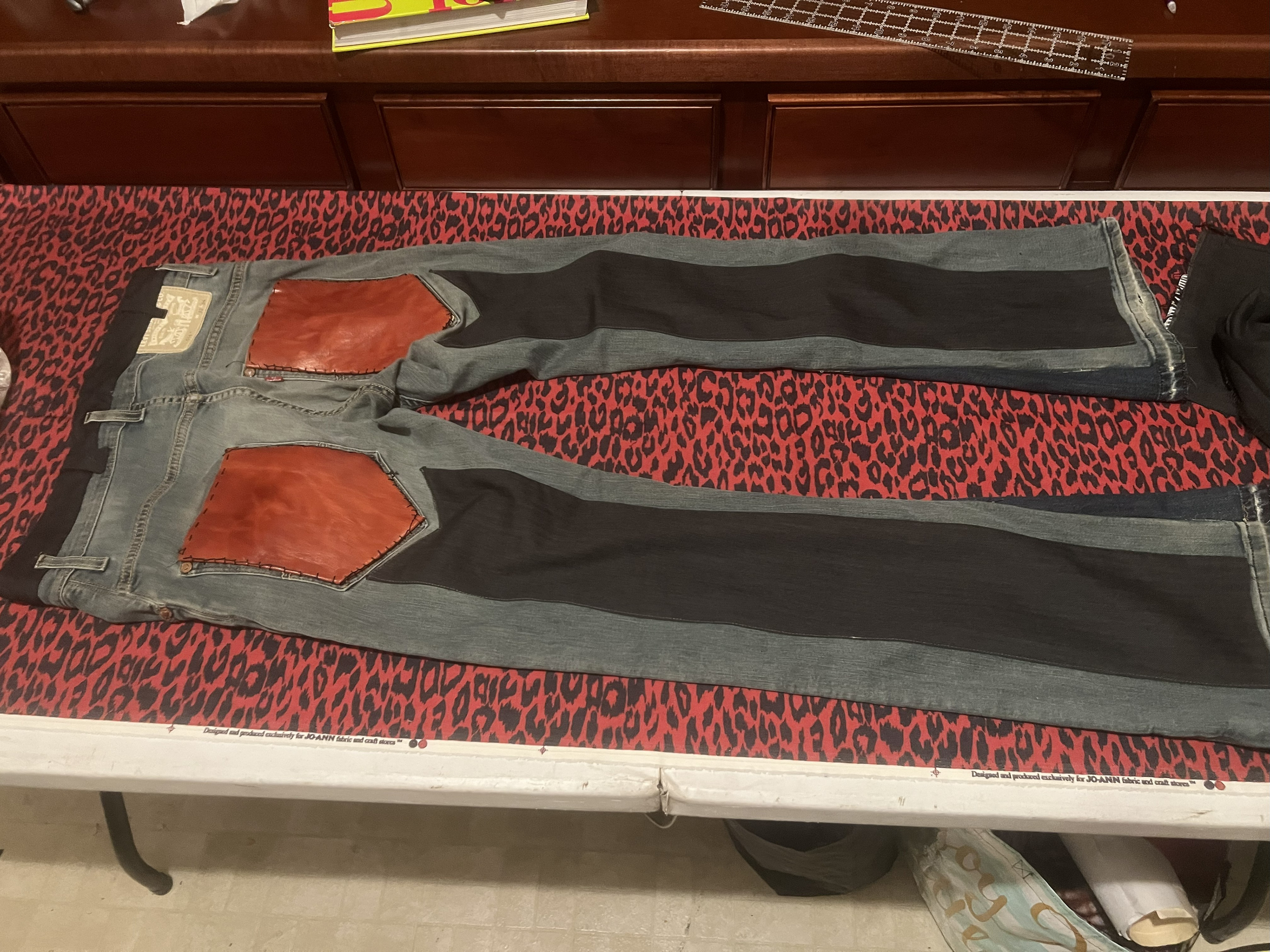 Custom upcycled grey denim with dark grey dress pants panels on inseam flare, back leg , waistband , and African red dyed leather