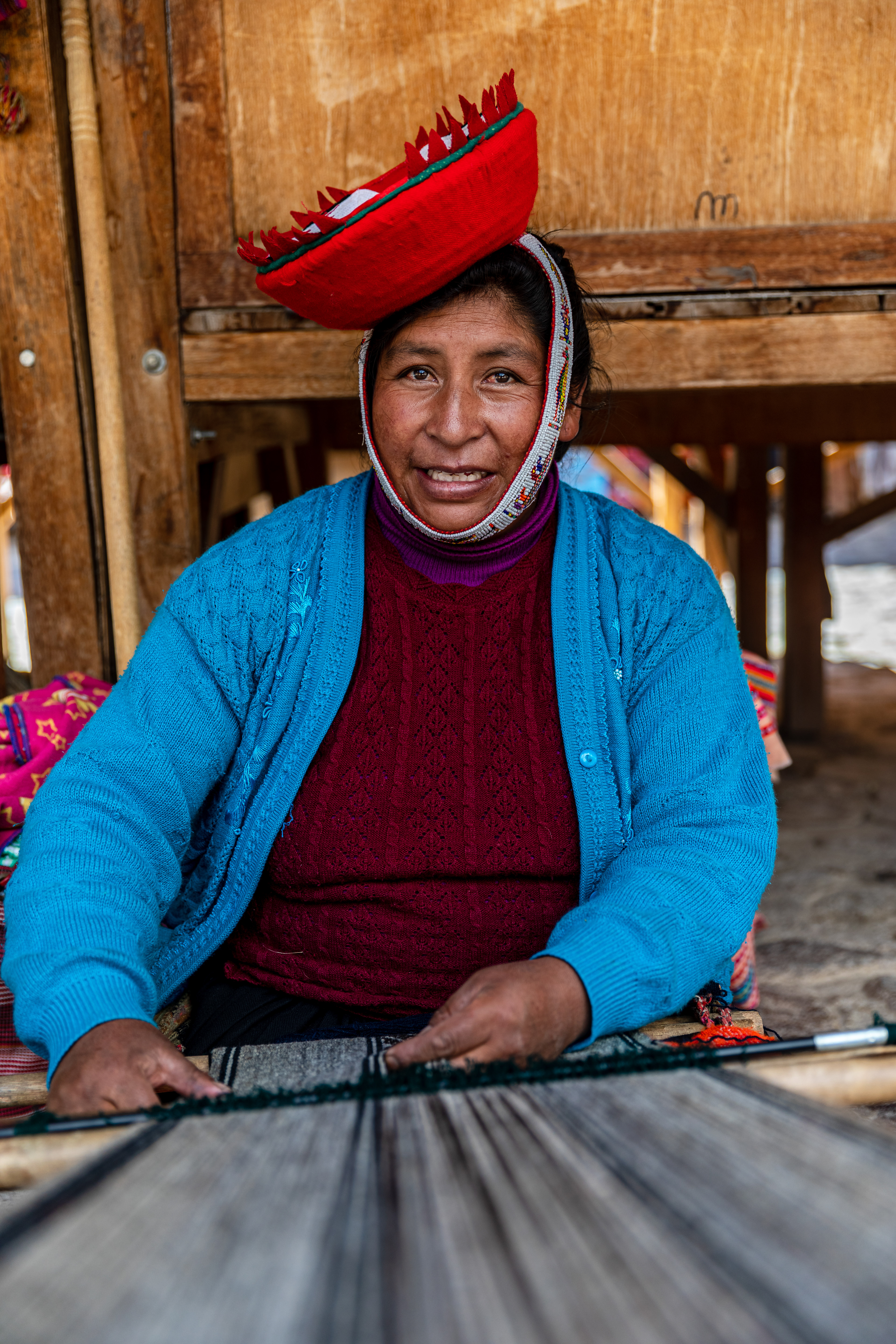 Woman knitting outside Ollantaytambo