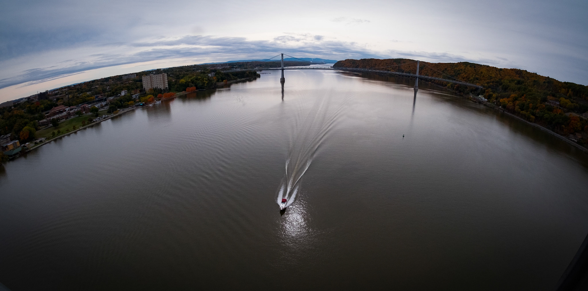 A power boat motors up the Hudson River in fall 2015