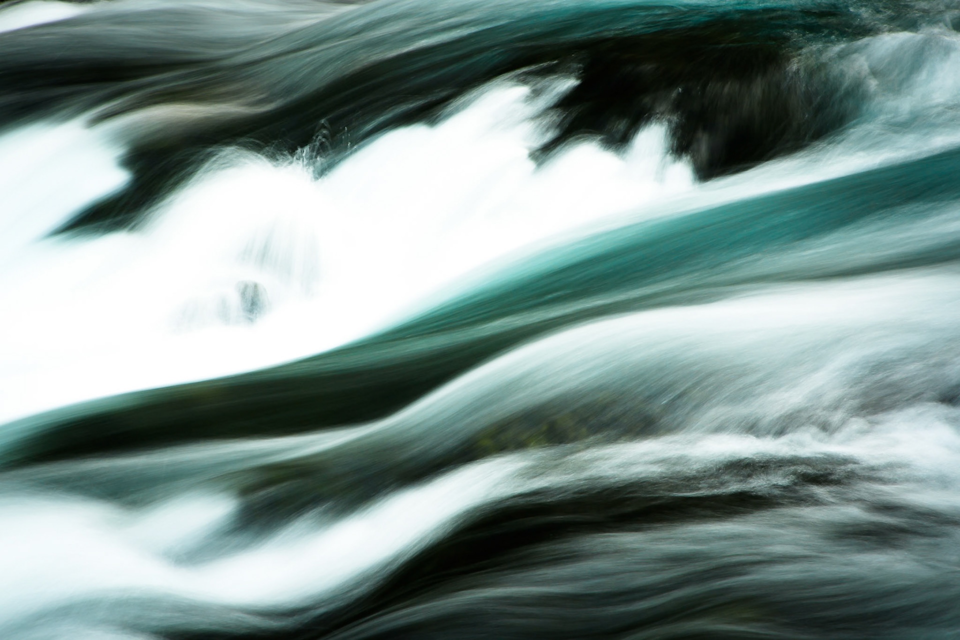Abstract closeup of McKenzie River flow in the forests of Cascade Mountains in Central Oregon