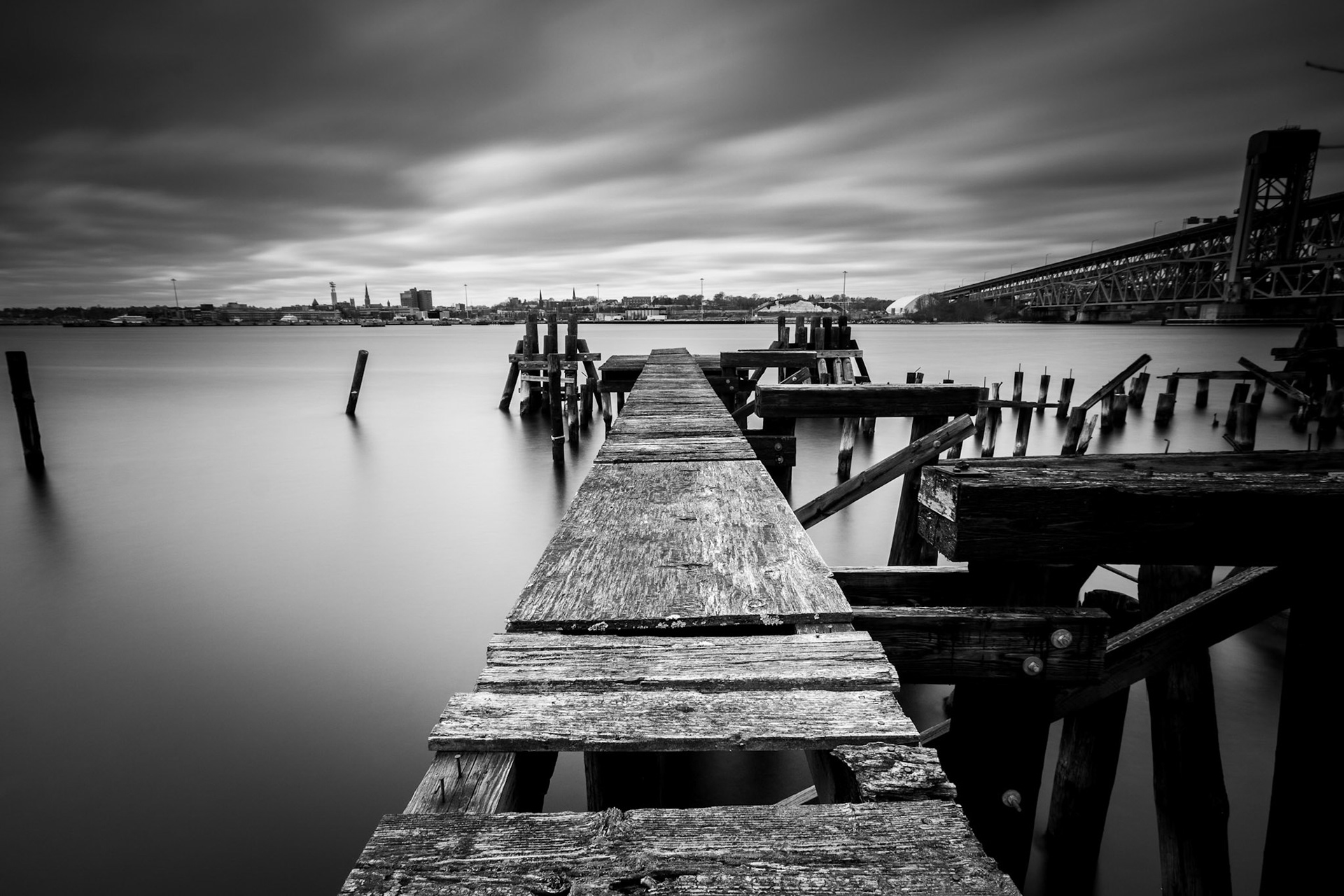 Black and white wooden dock that has decayed.