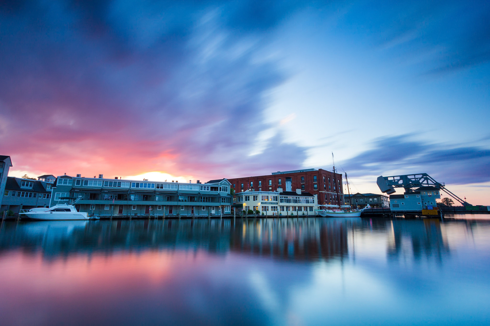 Long exposure of a colorful sunset at the Mystic River Drawbridge.