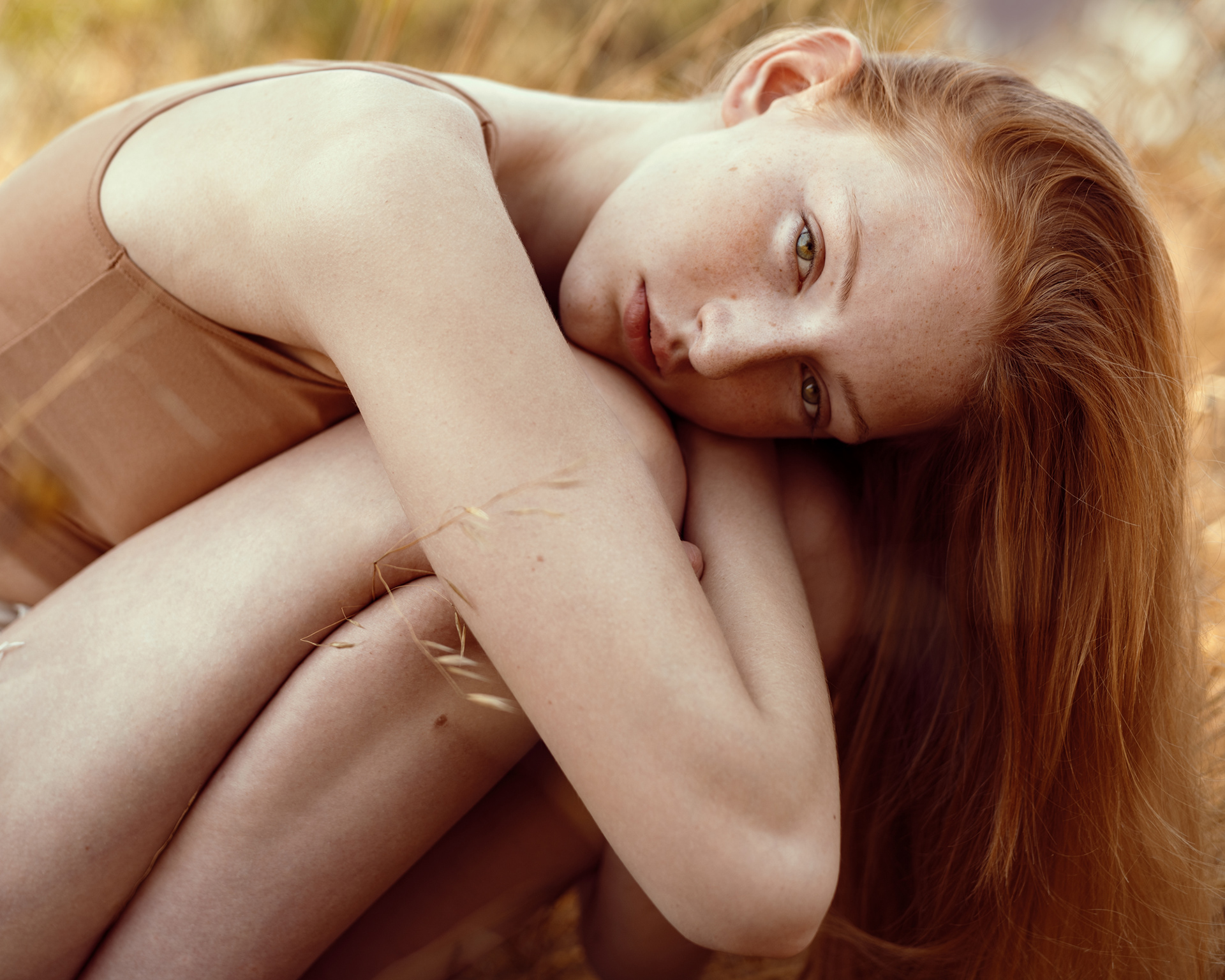 Natural light portrait of red-haired model in nude-toned dress with soft golden tones – Joanna Kustra lifestyle fashion photography