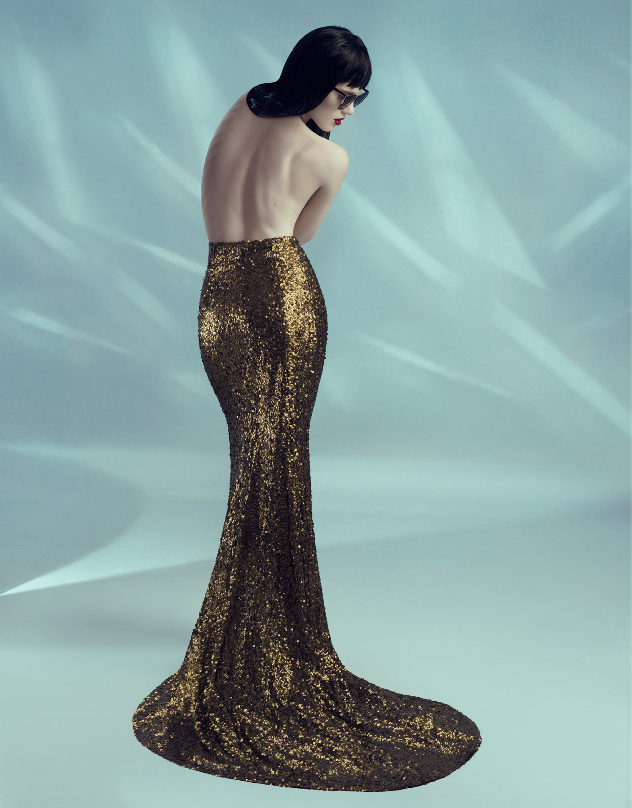 Studio fashion portrait of model in floor-length gold sequin gown with dramatic backless design – Joanna Kustra couture fashion photography
