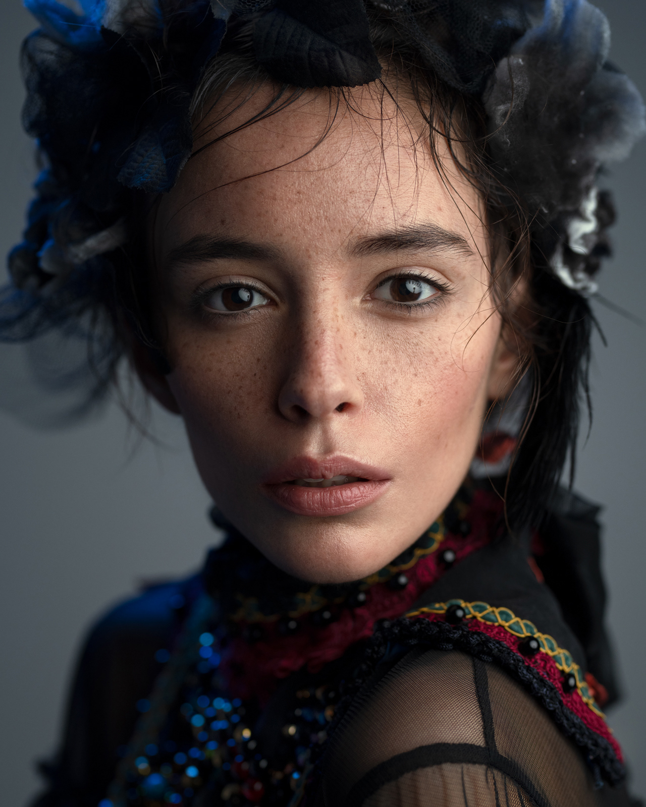 Studio portrait of model in black embellished gown with ornate headpiece – Joanna Kustra couture fashion photography