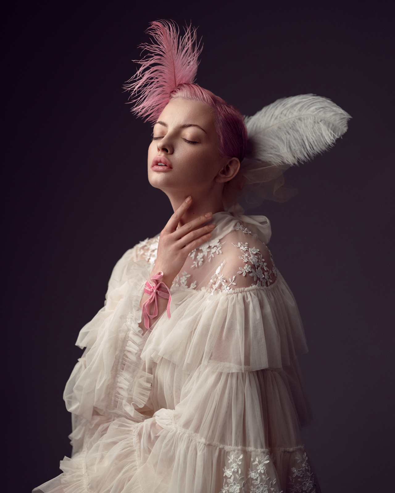Romantic fashion portrait of woman in feather headpiece and tiered sheer gown – Joanna Kustra couture photography