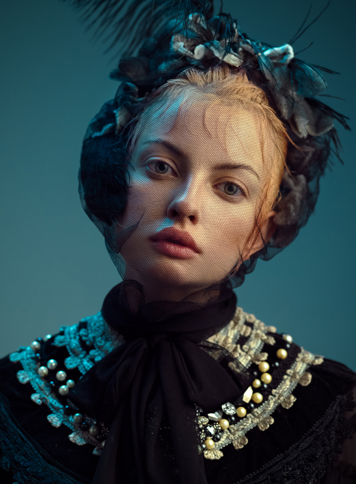 Fine art portrait in black gown with pearl embellishments and feathered headpiece – Joanna Kustra historical fashion photography