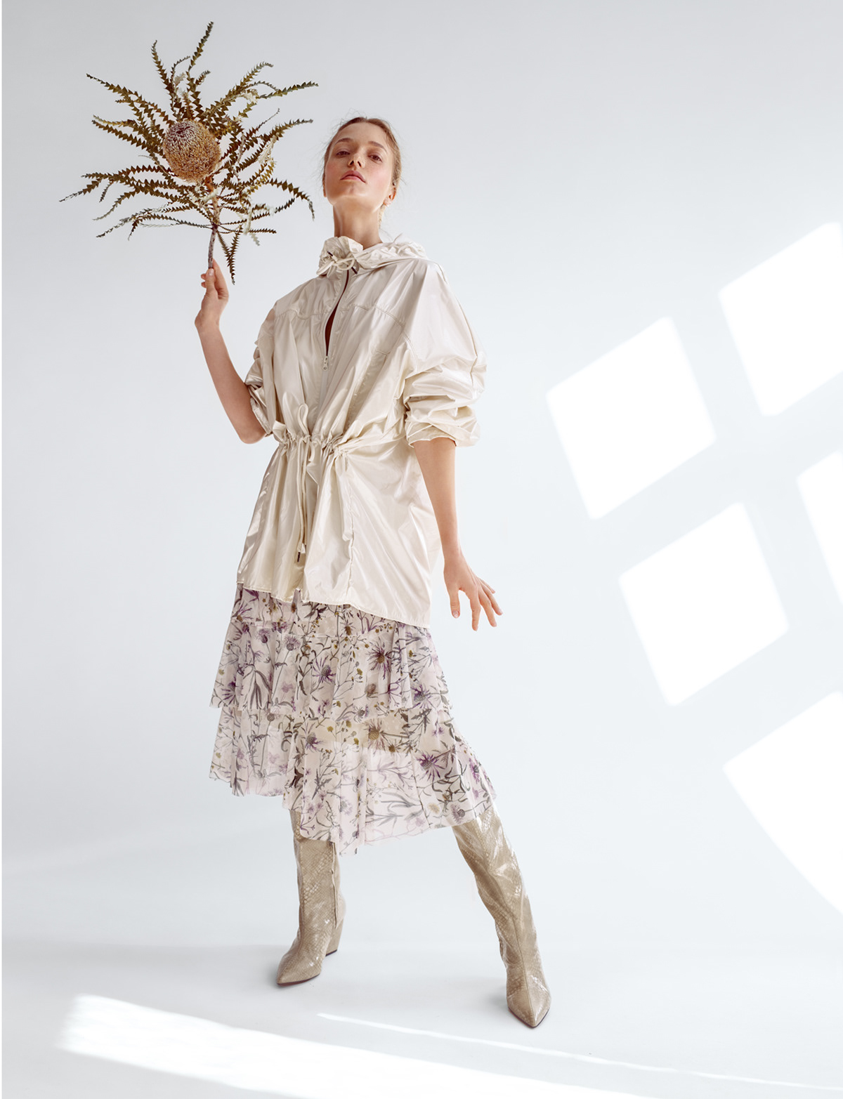 Studio fashion portrait of model in layered floral skirt and white blouse holding botanical bouquet – Joanna Kustra creative editorial photography