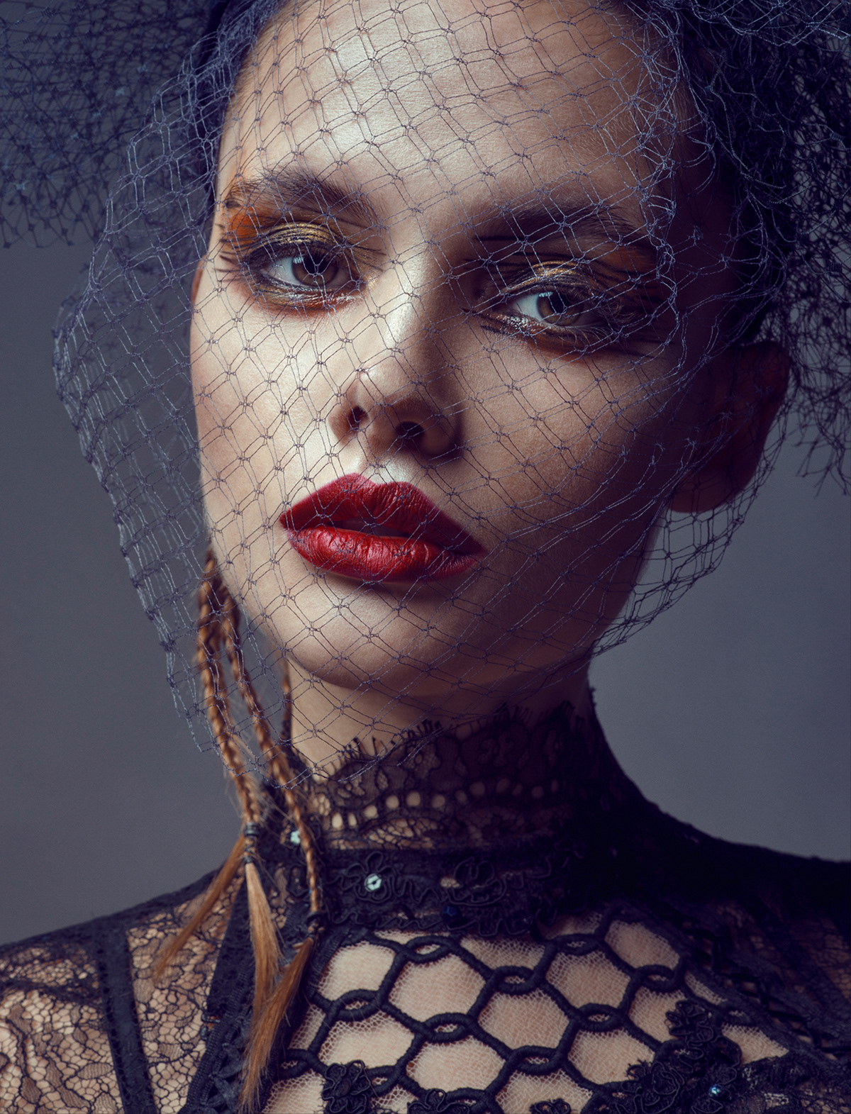Dramatic beauty portrait with netted veil, bold red lips, and gold eye makeup – Joanna Kustra fine art fashion photography