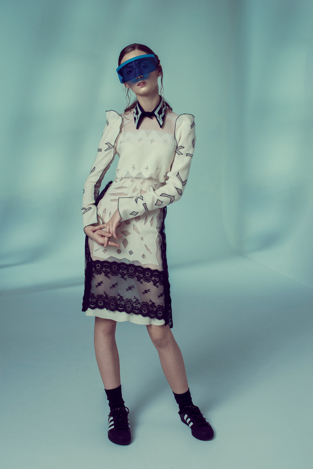 High-fashion studio portrait of model in cream lace dress with sports visor – Joanna Kustra creative editorial photography