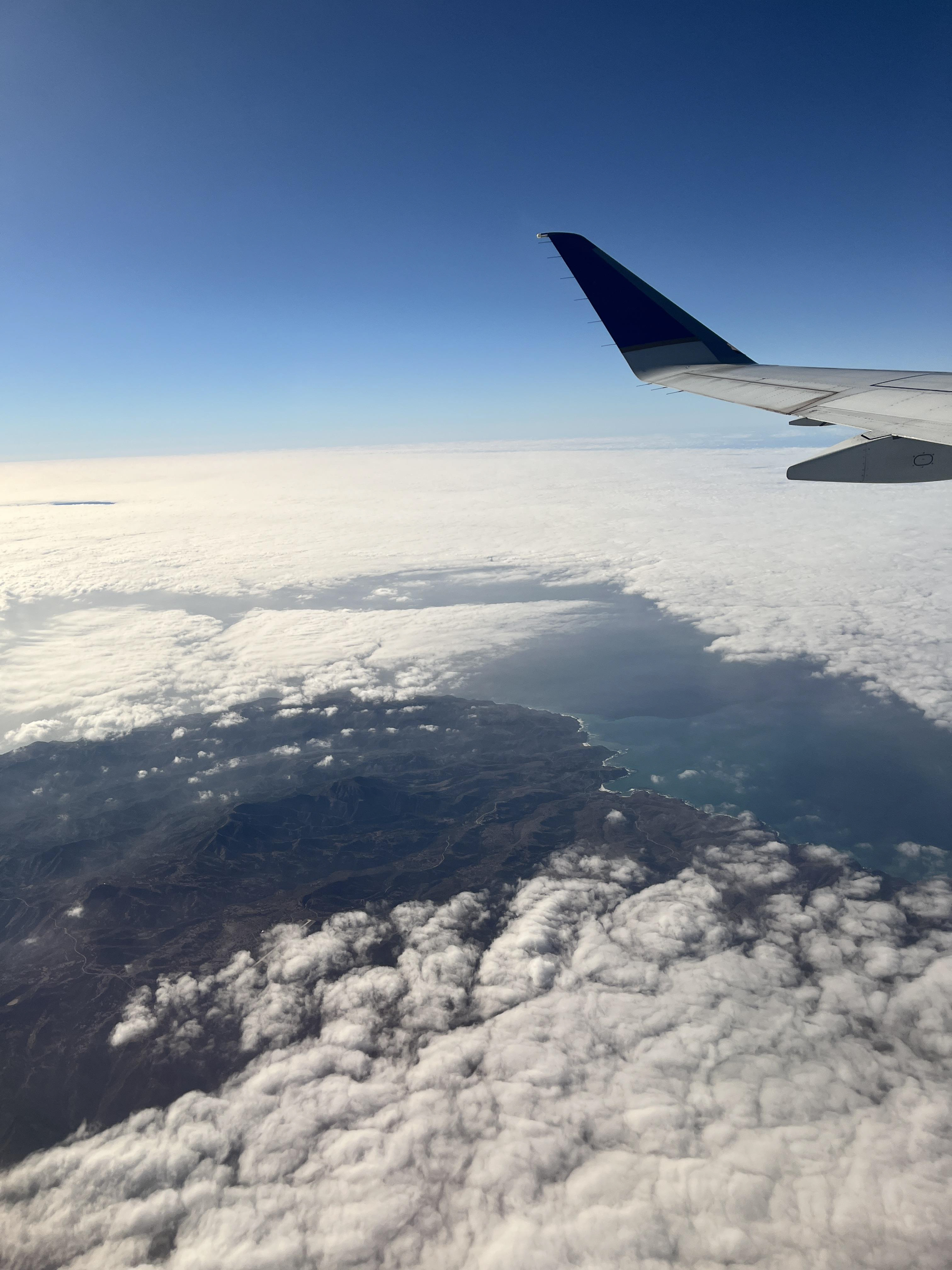 Flying over the cloudy California coast
