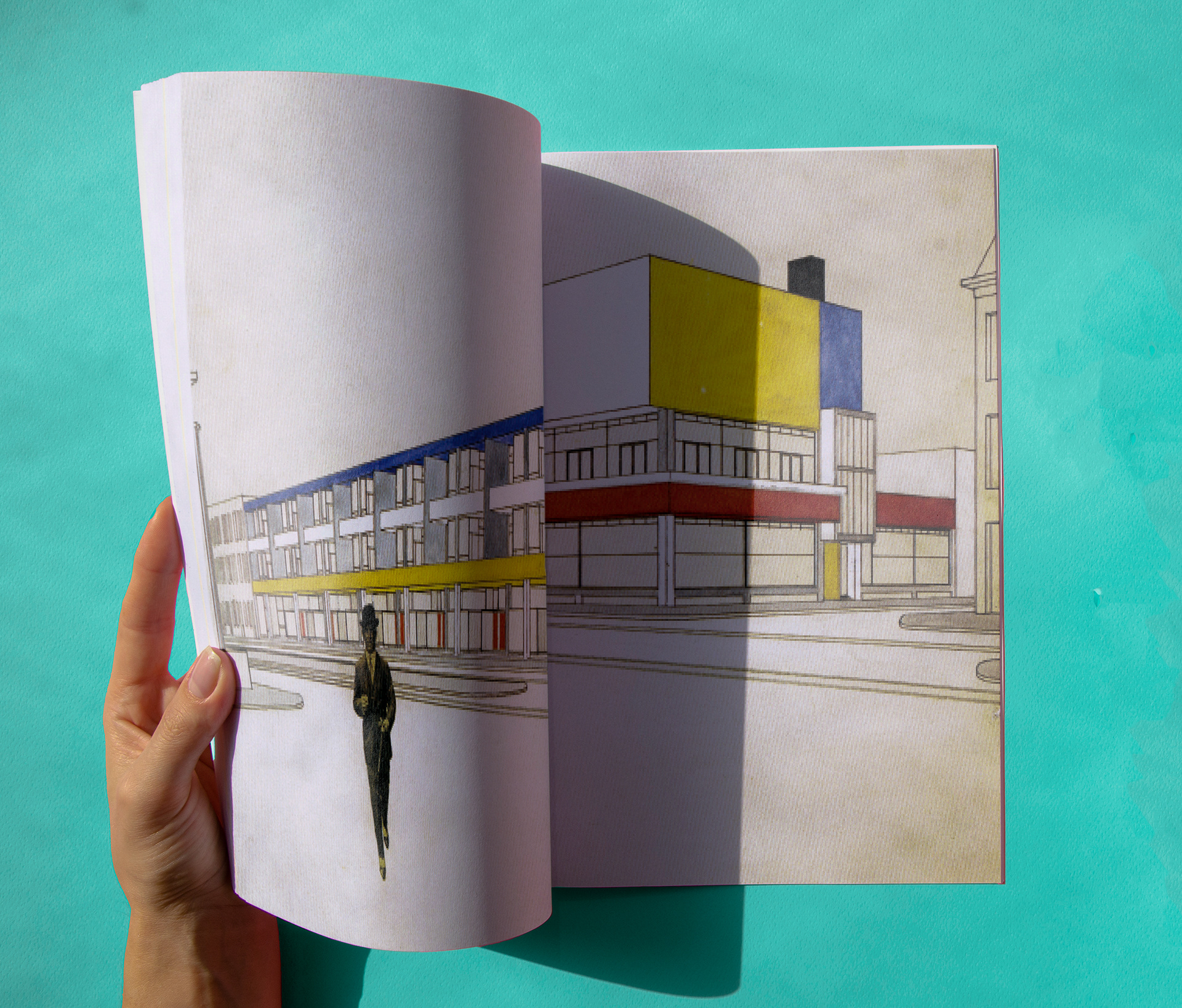 Hand opening catalog showing the endpapers that depict a man walking towards the viewer and a building with the De Stijl colors, red, blue, yellow, and white. Mock-up from http://www.freepik.com