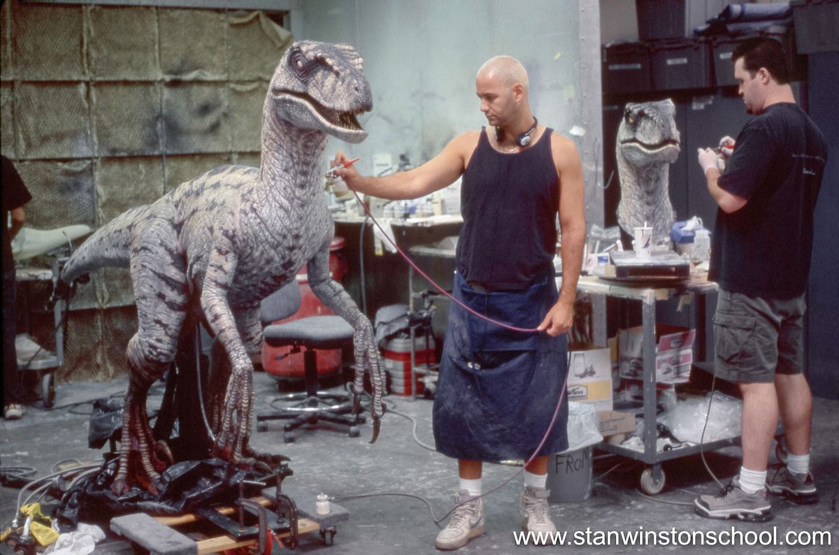 The MANY cables and hoses that will allow the puppet operate extend from the belly and are wrapped to protect them while we paint.