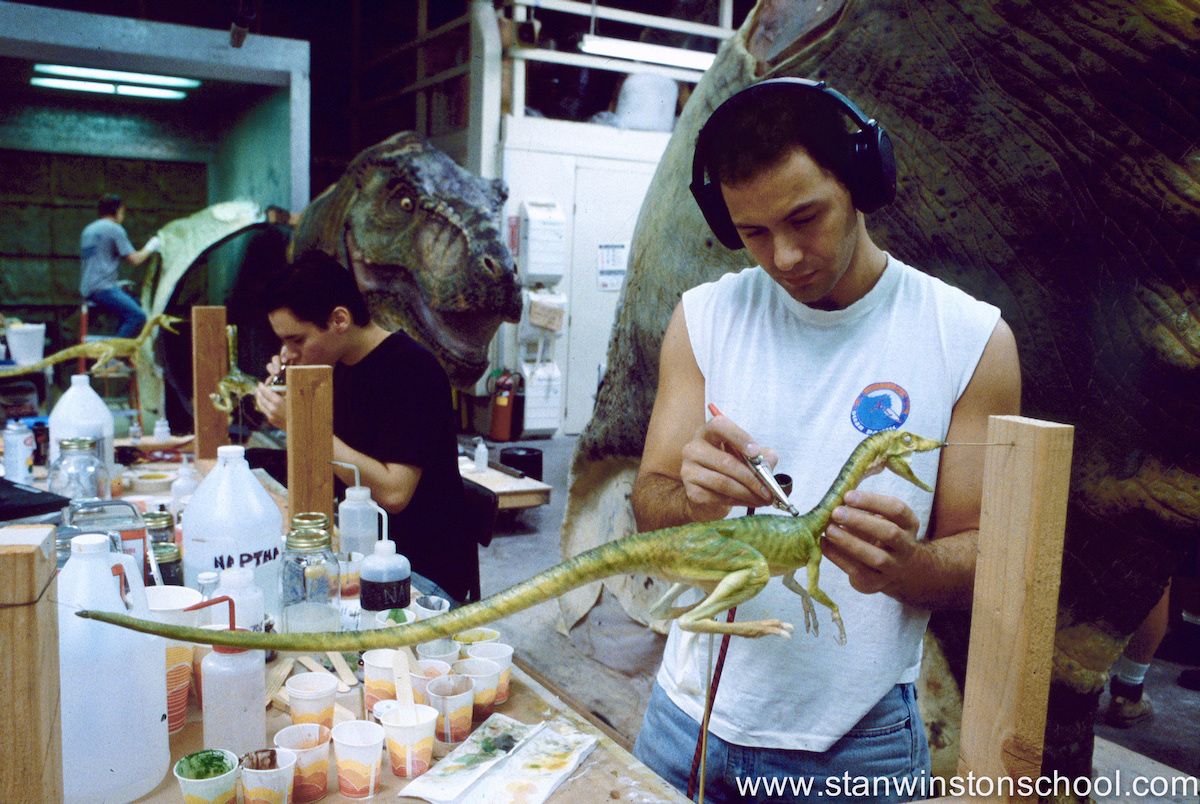 Painting a Compy along with artist Jason Matthews. The male T-Rex is behind us in pieces.