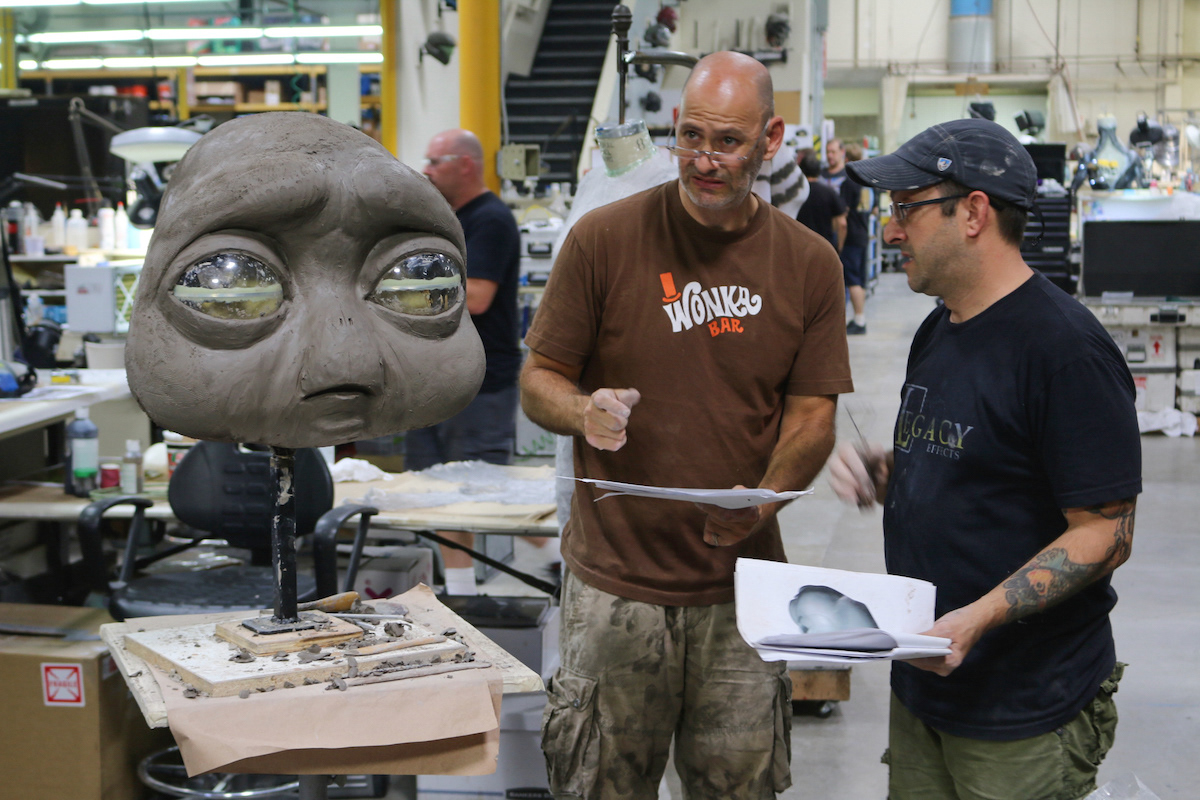 Ian Lome and I with our stack of design prints discussing the shape of the sculpt. Nice look on my face!