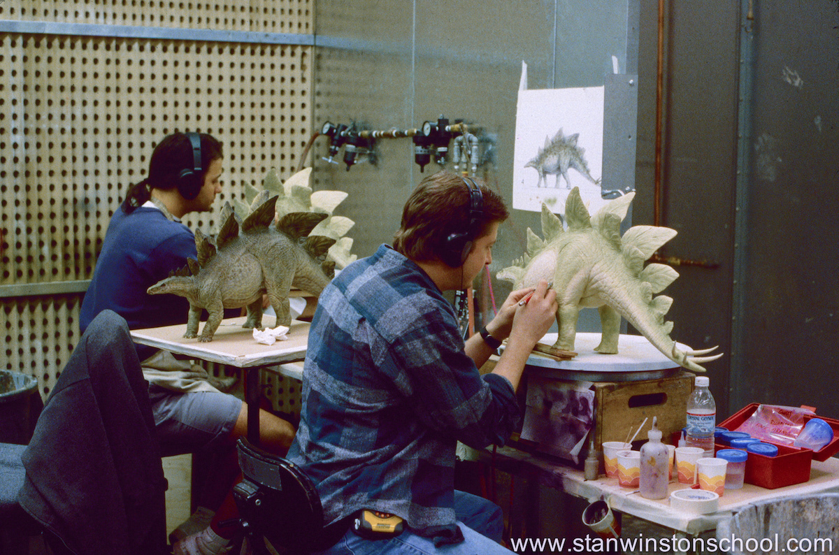 Painting 3 exact copies of the maquette next to lead artist Mark Maitre. Between us is the original "master" painted stegosaurus done by Mark so we could assure to match style & color.