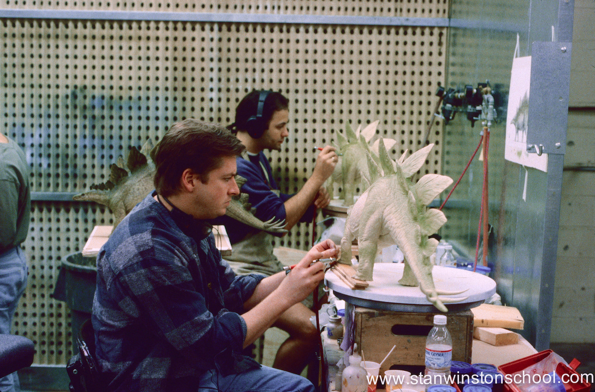Painting 3 exact copies of the maquette next to lead artist Mark Maitre. Between us is the original "master" painted stegosaurus done by Mark so we could assure to match style & color.