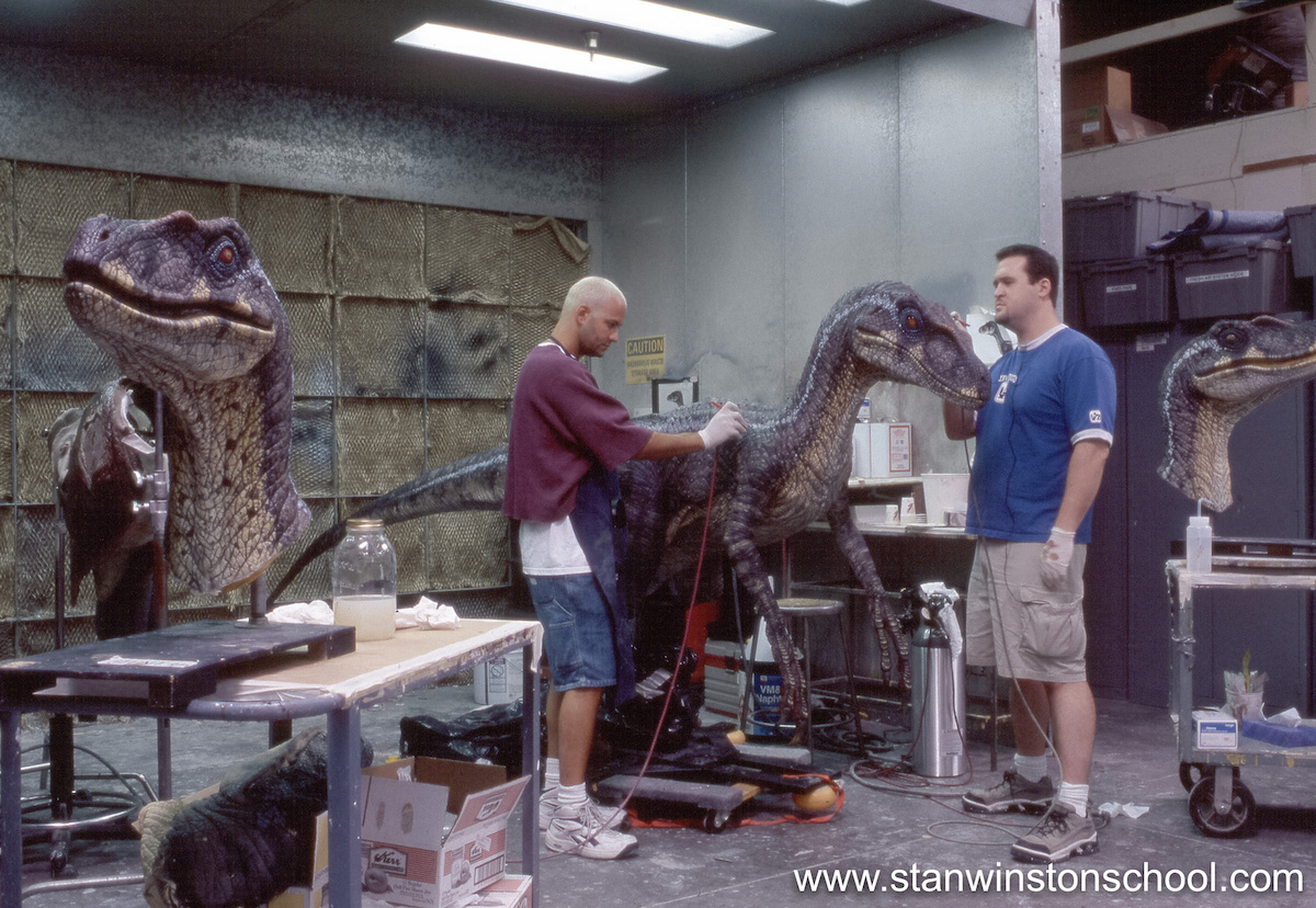 The master painted head is in the foreground while Trevor and I paint the male Velociraptor animatronic puppet.