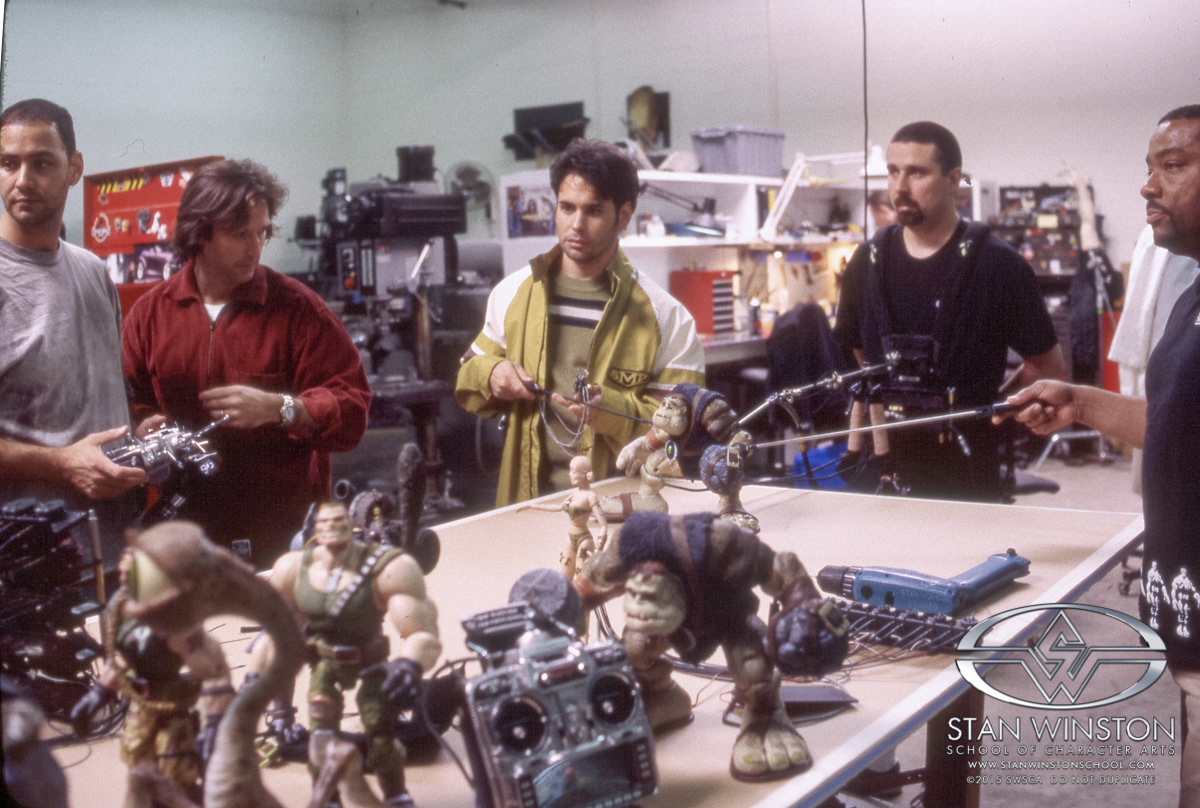 I'm on the radio controller this time, making Slamfist's head look around while he walks. John Rosengrant oversees me, Christopher Swift on right arm, Keith Marbury on the left and Al Sousa and the walking rig.  On film, I was the one who controlled the head, face and body on all of the Slamfist puppets.