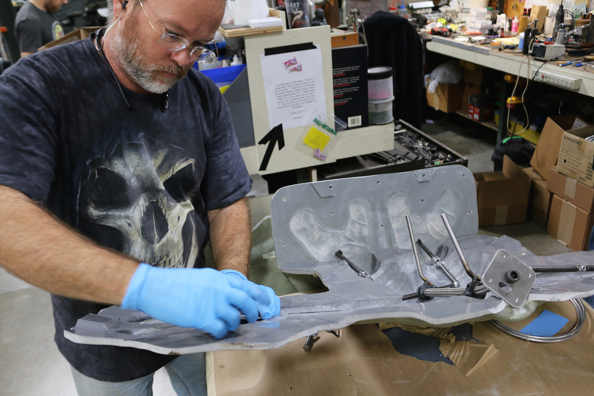 Vance Hartwell, the lead on this project, works with the puppet armature that he and Richard Landon were creating to make sure it fits properly inside the body mold.