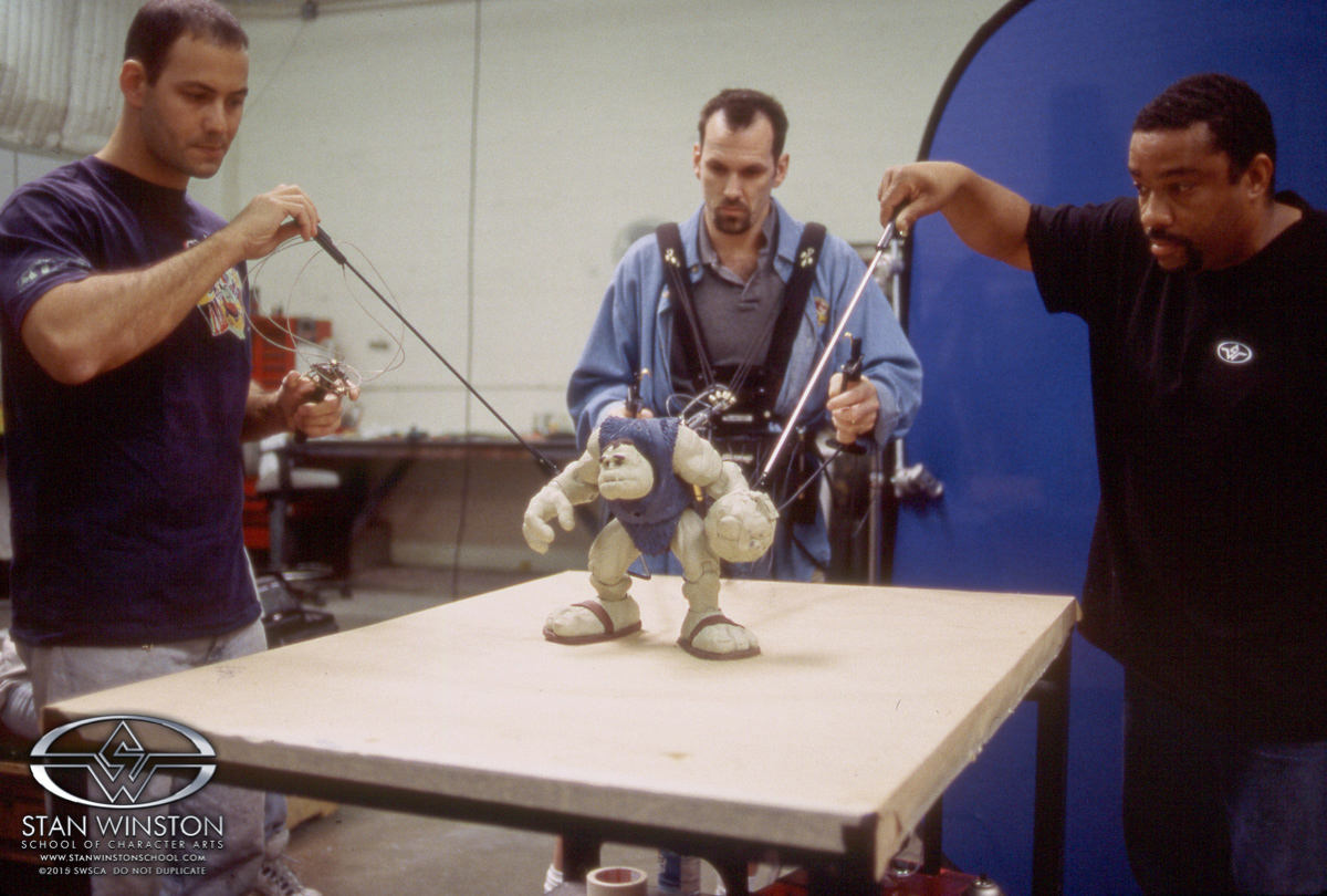 Simultaneous to our making the puppets, puppeteering rehearsals began so we could get our performances down prior to filming. Here, Mechanical Dept supervisor Alan Scott is attached to the "Walking" puppet legs while Keith Marbury and I control Slamfist's arms.