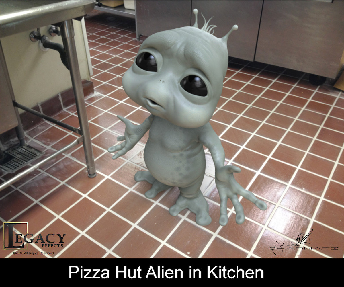 The alien in a kitchen setting.