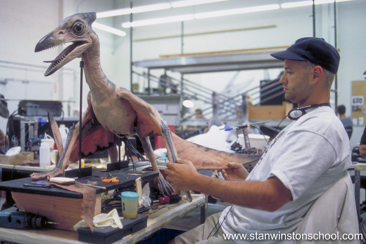 Attaching the wing "skin" onto the baby pteranodon arms and trying to make sure they don't get unnatural kinks and folds while it moves.
