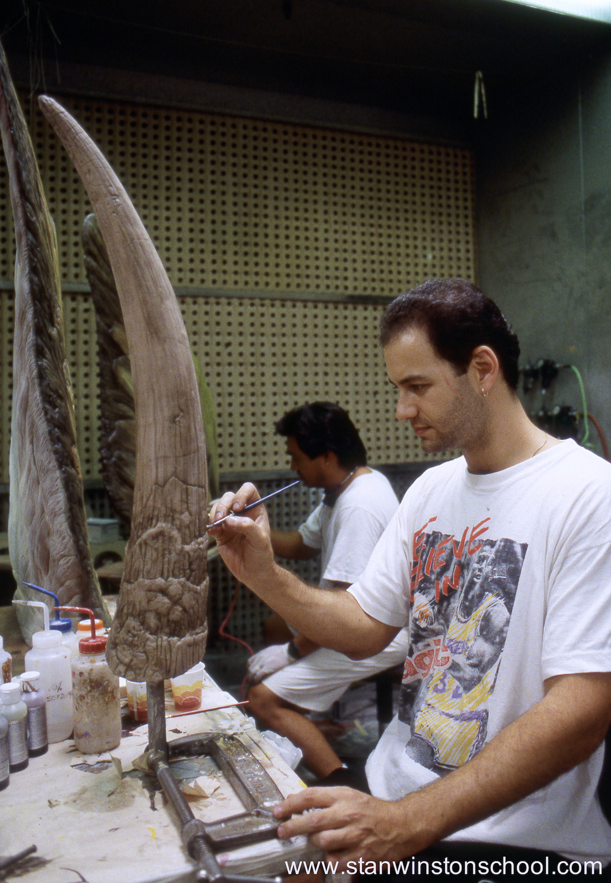 Painting the final steg tail spikes. Michael Ornelaz paints one of the back plates behind me.