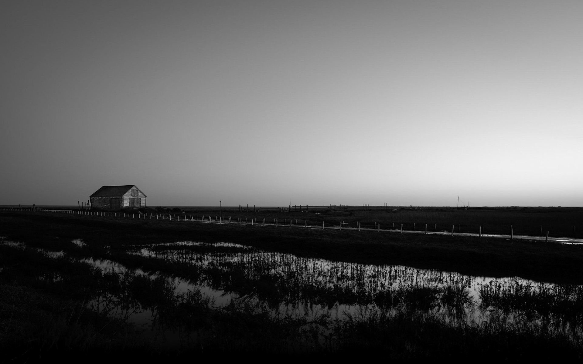 An old barn in black and white minimalist and isolated surroundings