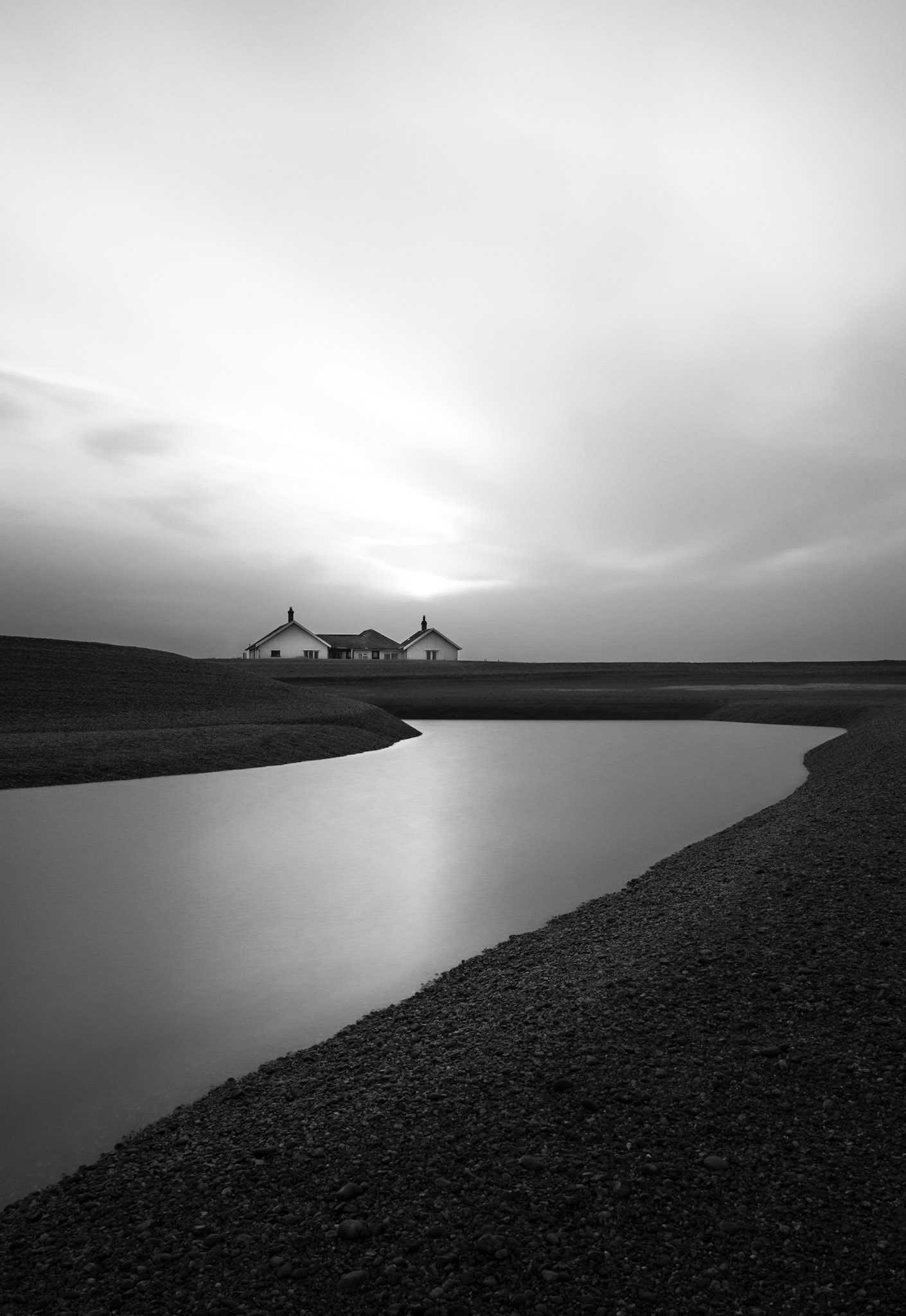 Black and white coastguard cottage during sunset, Suffolk. Costas Kariolis