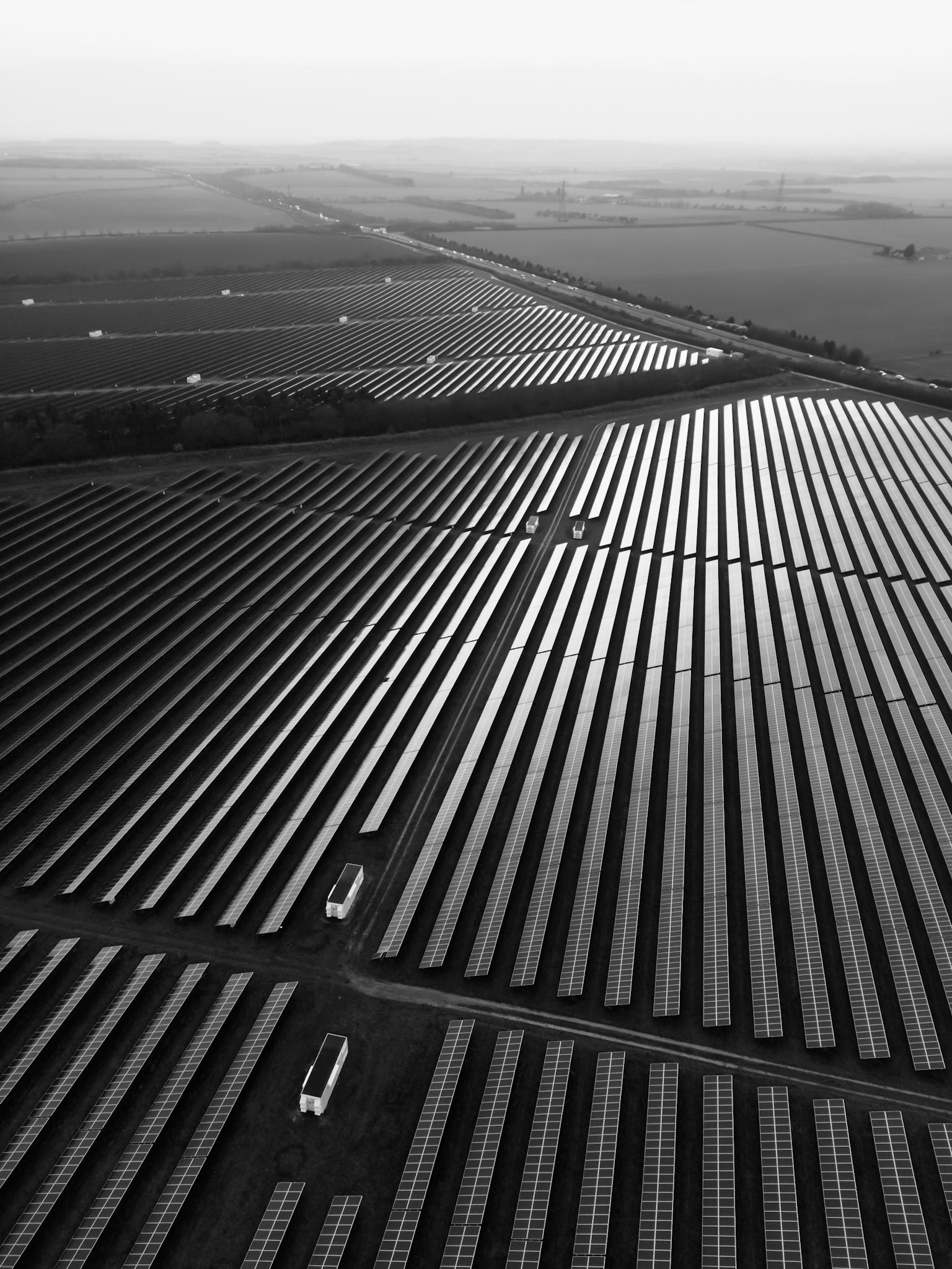 Black and white oblique aerial photograph overlooking a solar farm, U.K.